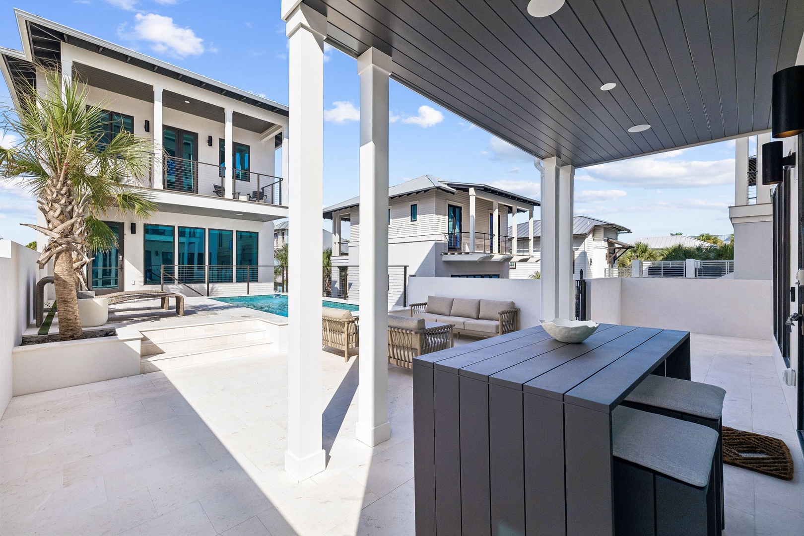 Step into your covered patio and feel the ease of indoor-outdoor living at its finest. Gather around the modern outdoor dining table while palm trees sway overhead, or lounge poolside knowing your escape awaits just beyond the door.