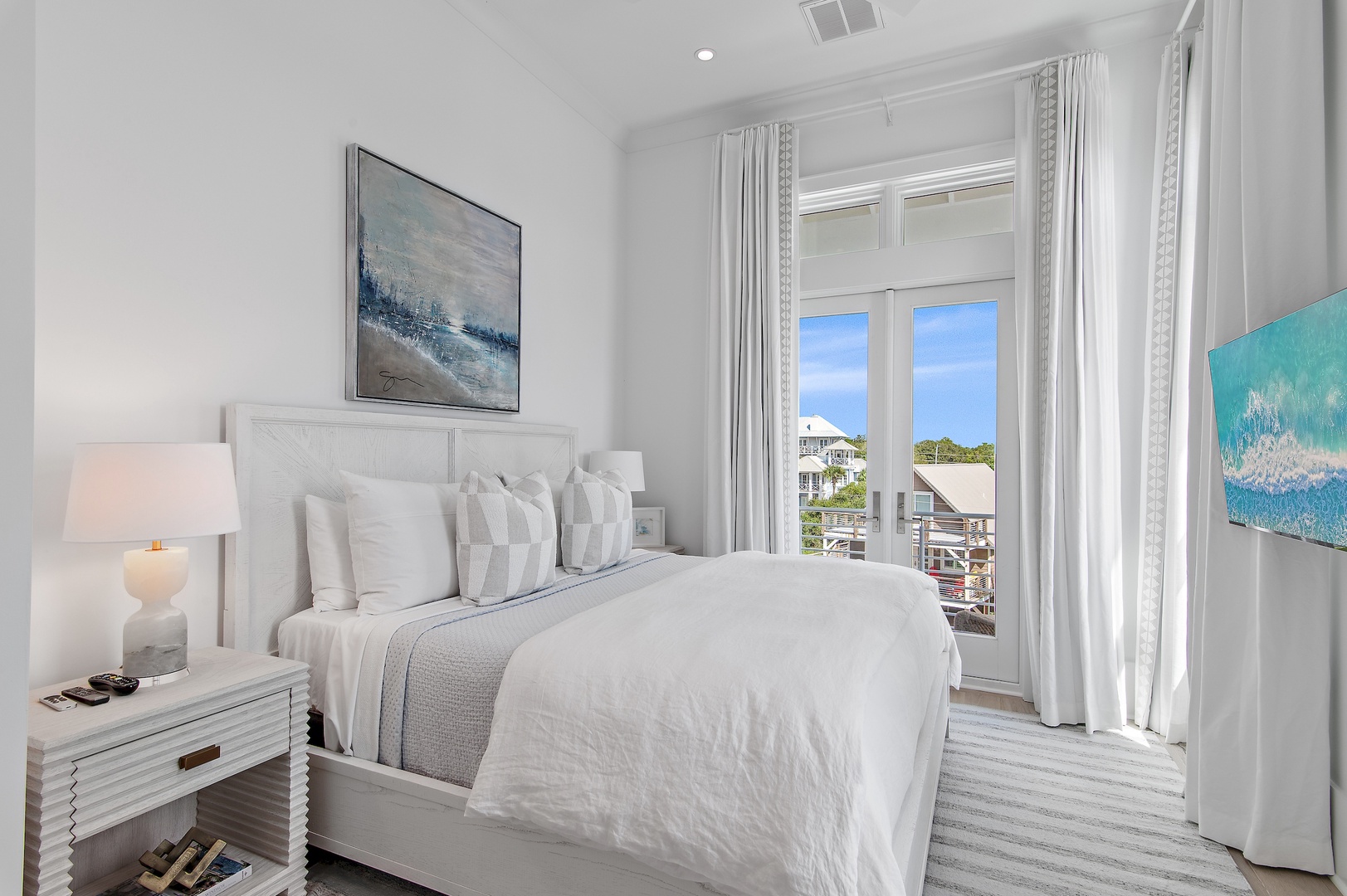 Drift off in this peaceful bedroom where soft white linens invite you to unwind, while your private balcony opens to ocean breezes and coastal views beyond.
