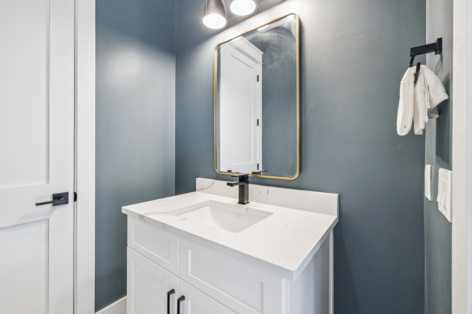 Your private bathroom features elegant marble countertops, modern fixtures, and stylish pendant lighting for a luxurious morning routine.