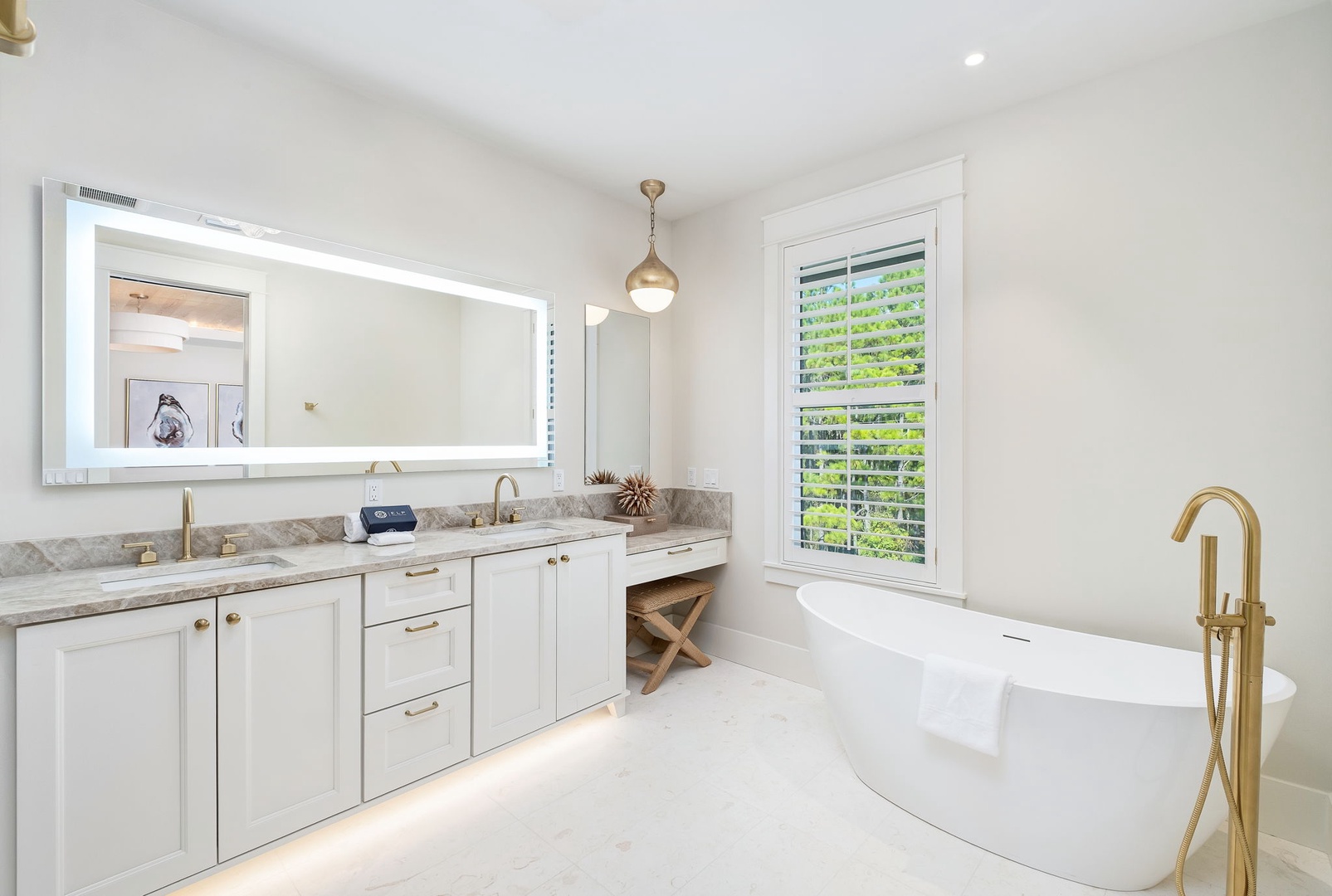 Indulge in your private sanctuary with dual vanities, a gleaming soaking tub, and elegant gold fixtures that add a touch of luxury to your daily routine.