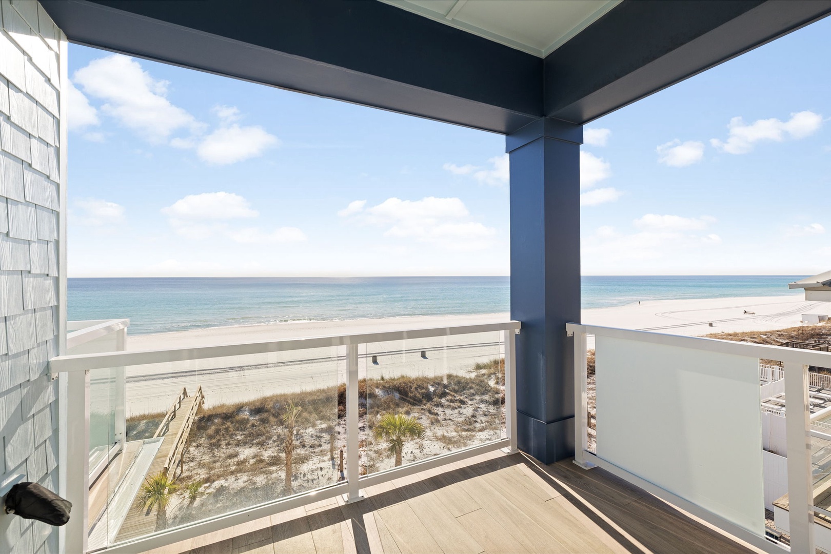 Panoramic ocean views and sea breezes await you on this covered balcony overlooking pristine white sand beaches.