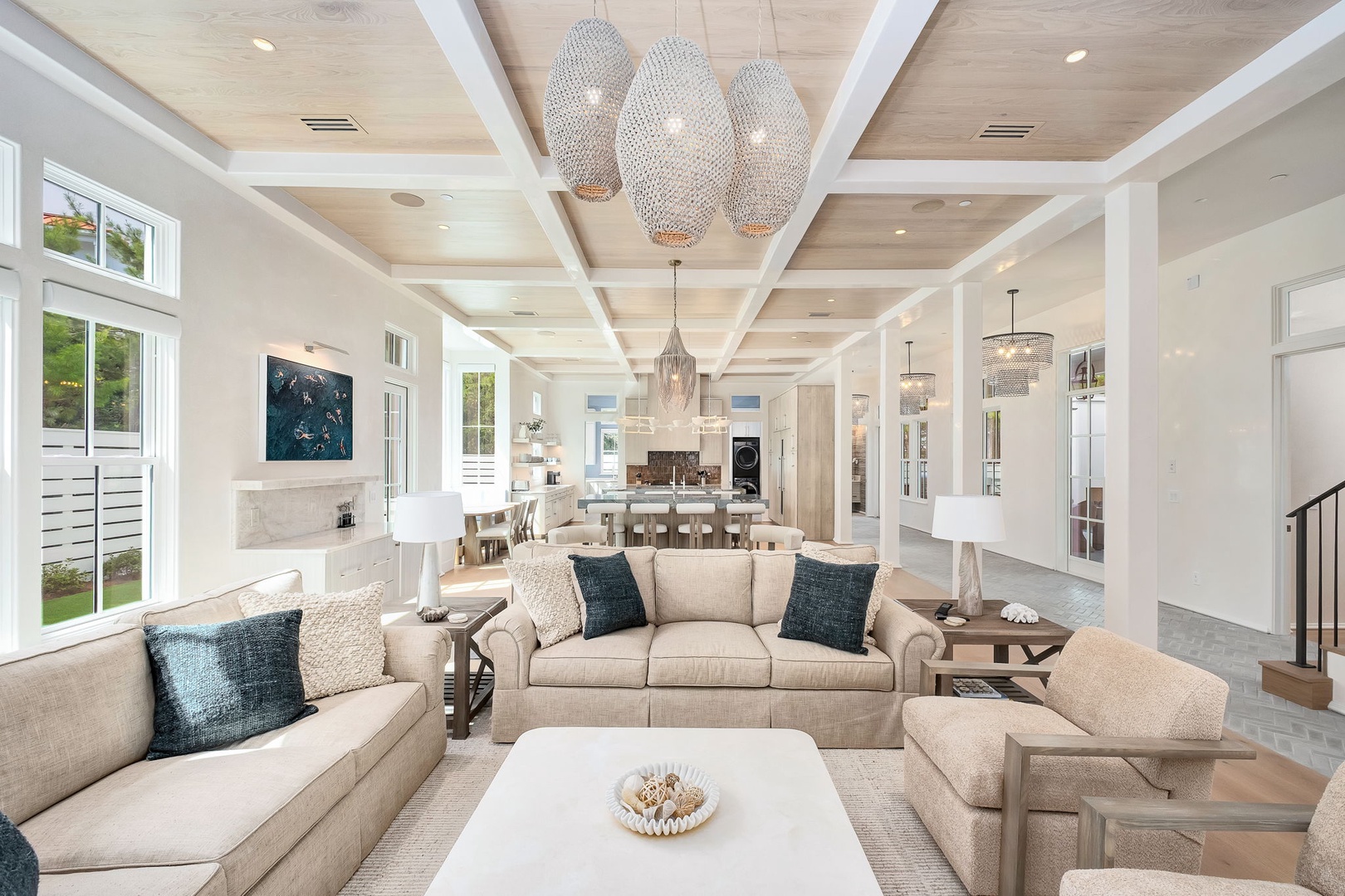Stunning open-concept living space with light wood ceilings and designer pendant lights. Beautifully appointed great room perfect for gathering with loved ones.
