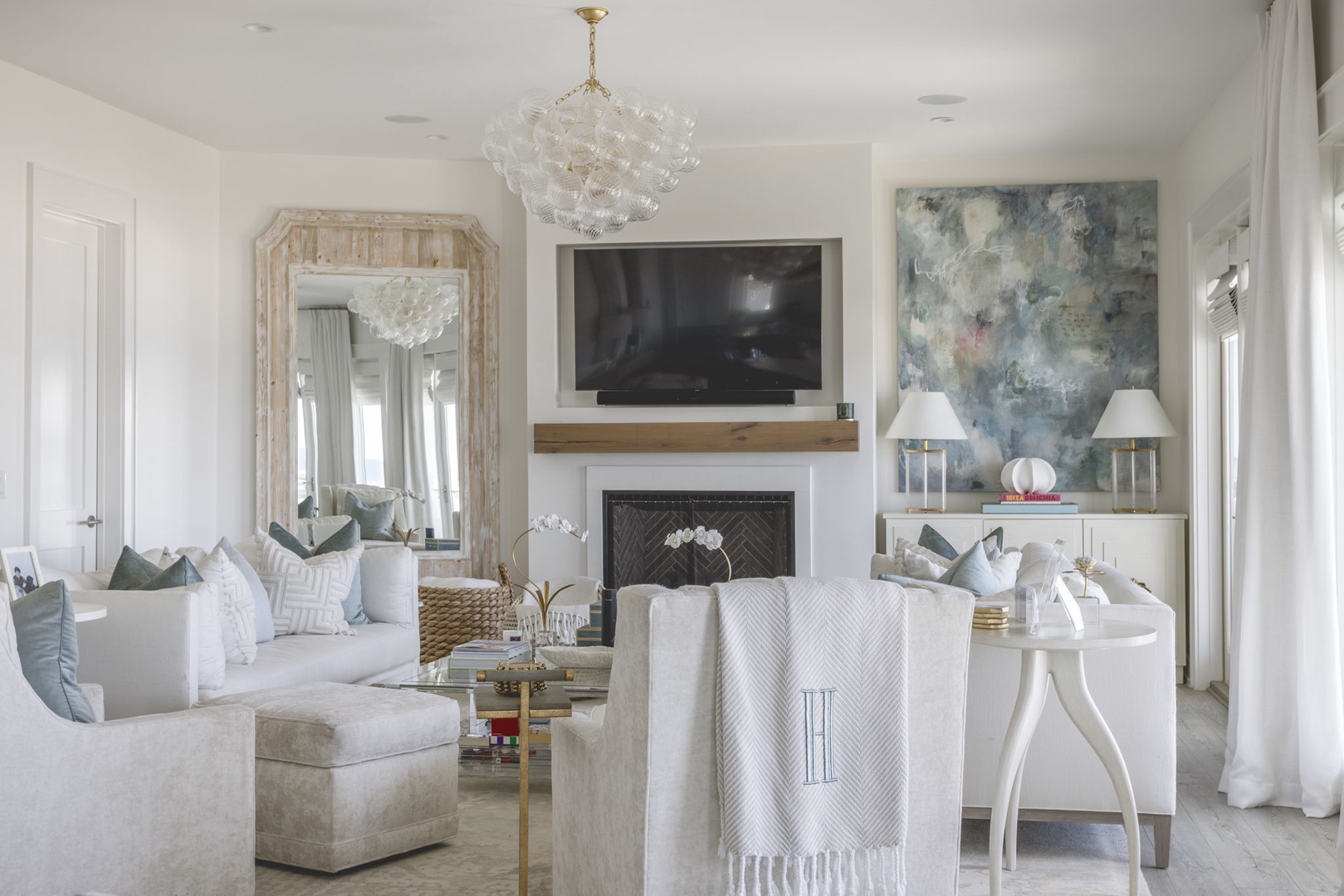 Your bright, airy living space welcomes you with plush seating, a cozy fireplace, and elegant chandelier—perfect for unwinding after exploring the area.