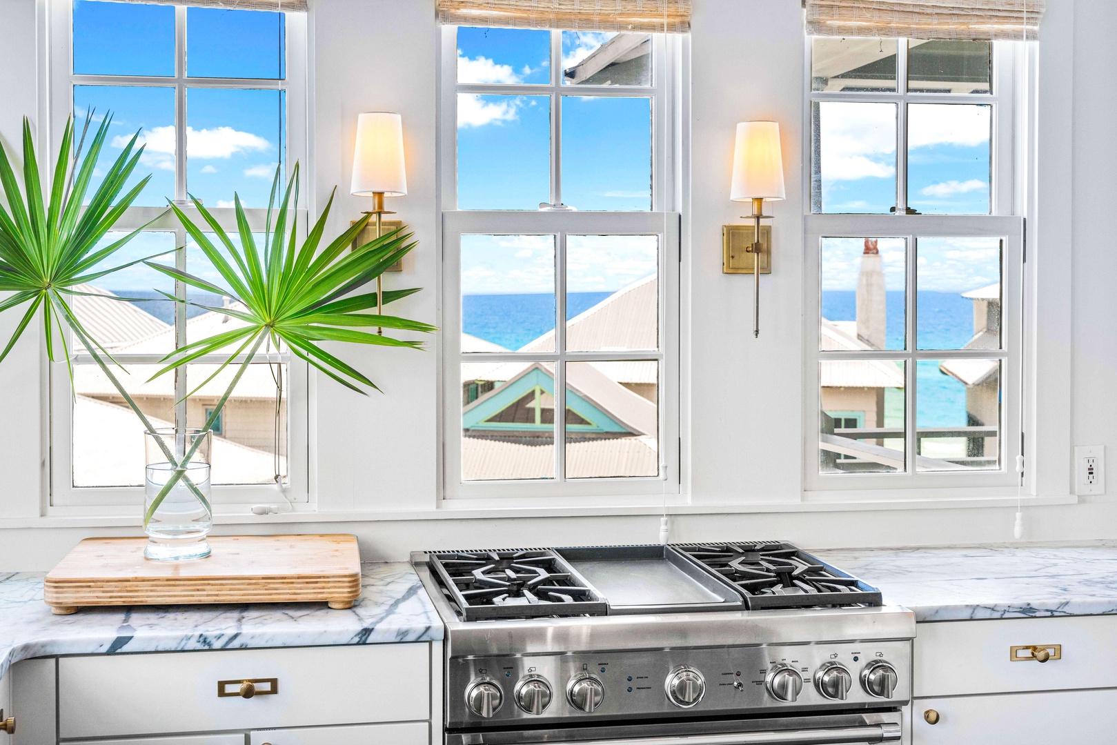 Your gourmet kitchen features marble countertops and a professional gas range, with stunning ocean views just steps away from your workspace.