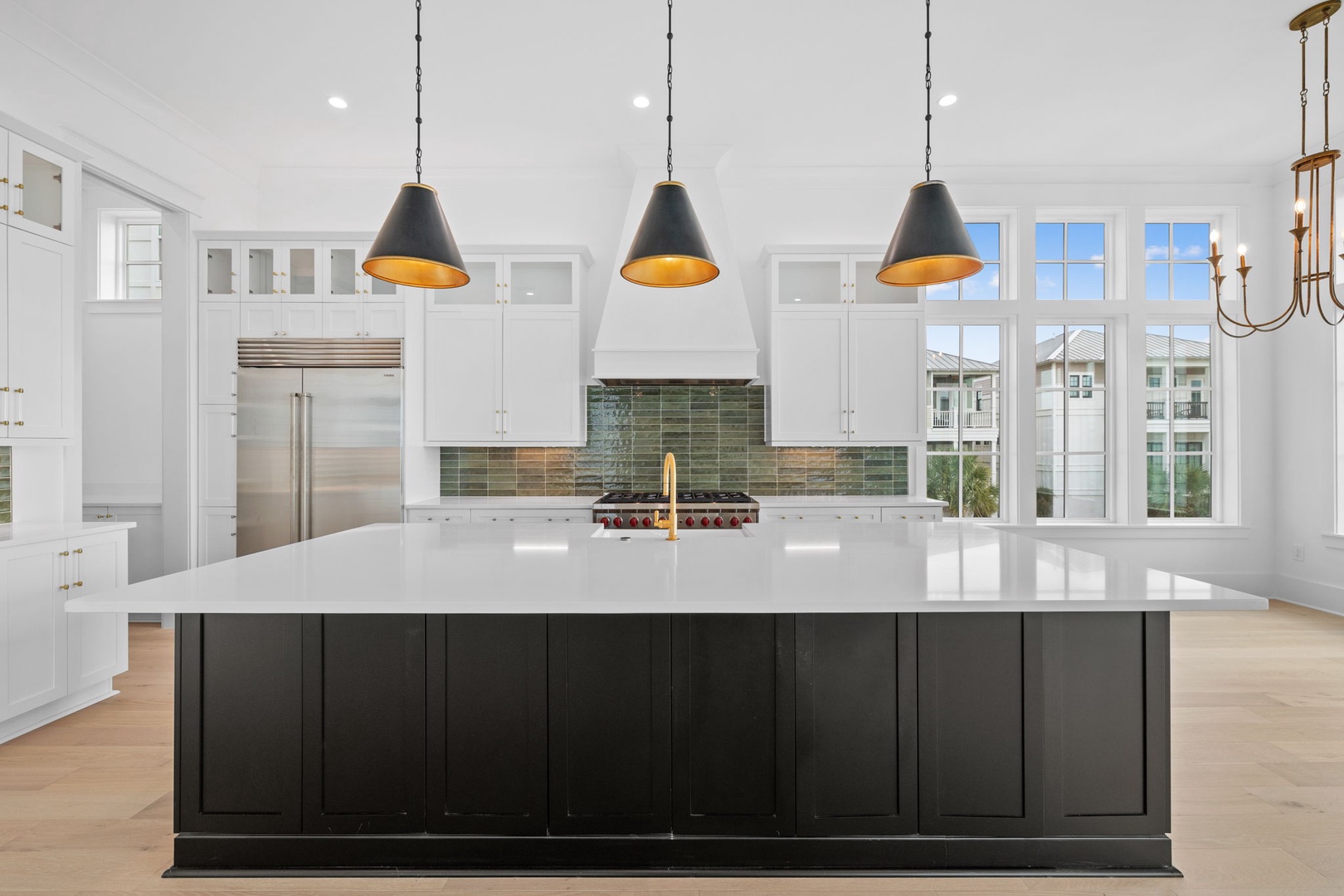 Your stunning kitchen awaits with gleaming counters, professional appliances, and pendant lighting perfect for cooking memorable meals together.