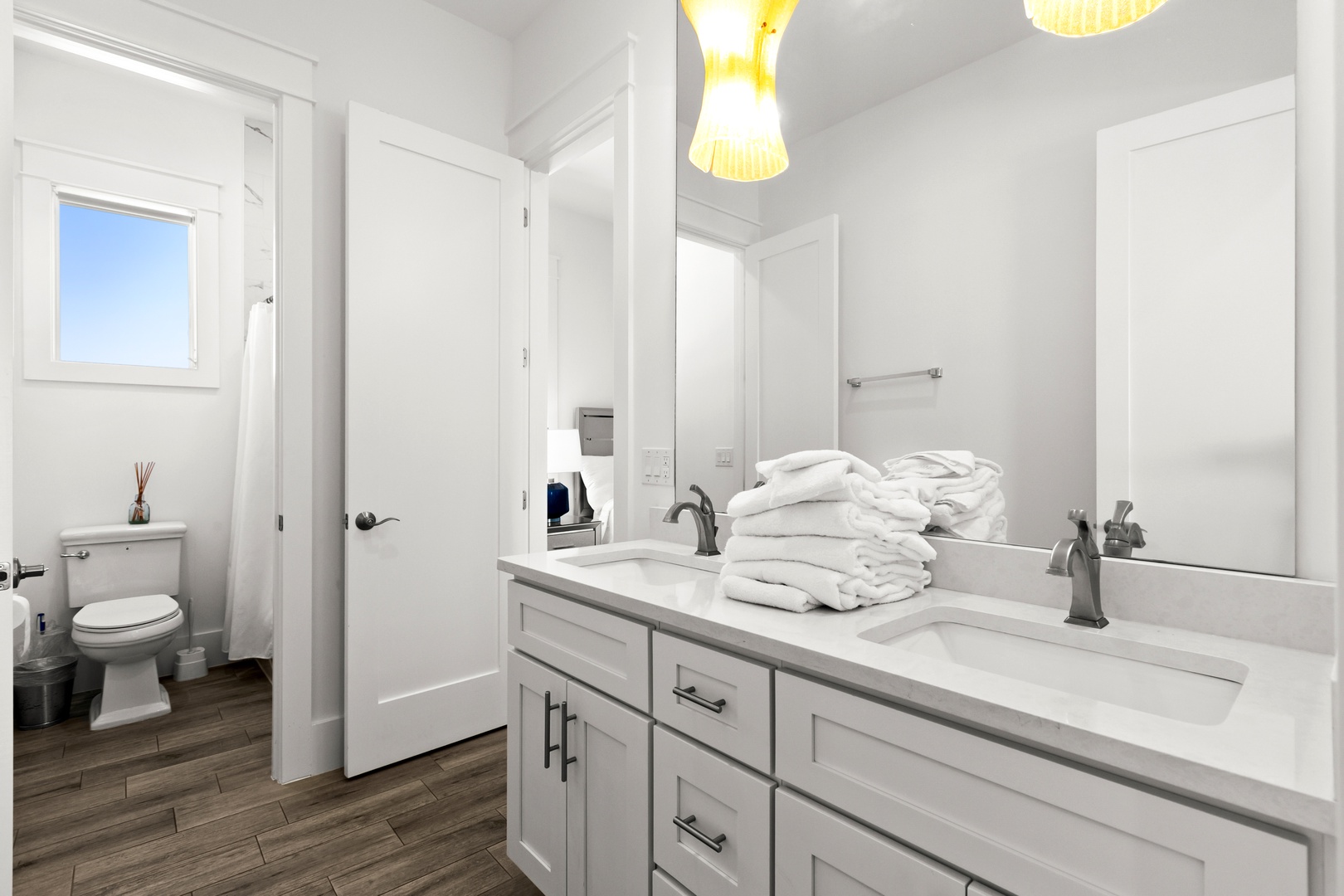 Freshen up in your bright, spacious bathroom featuring elegant fixtures, plush towels, and modern lighting that makes getting ready a breeze.