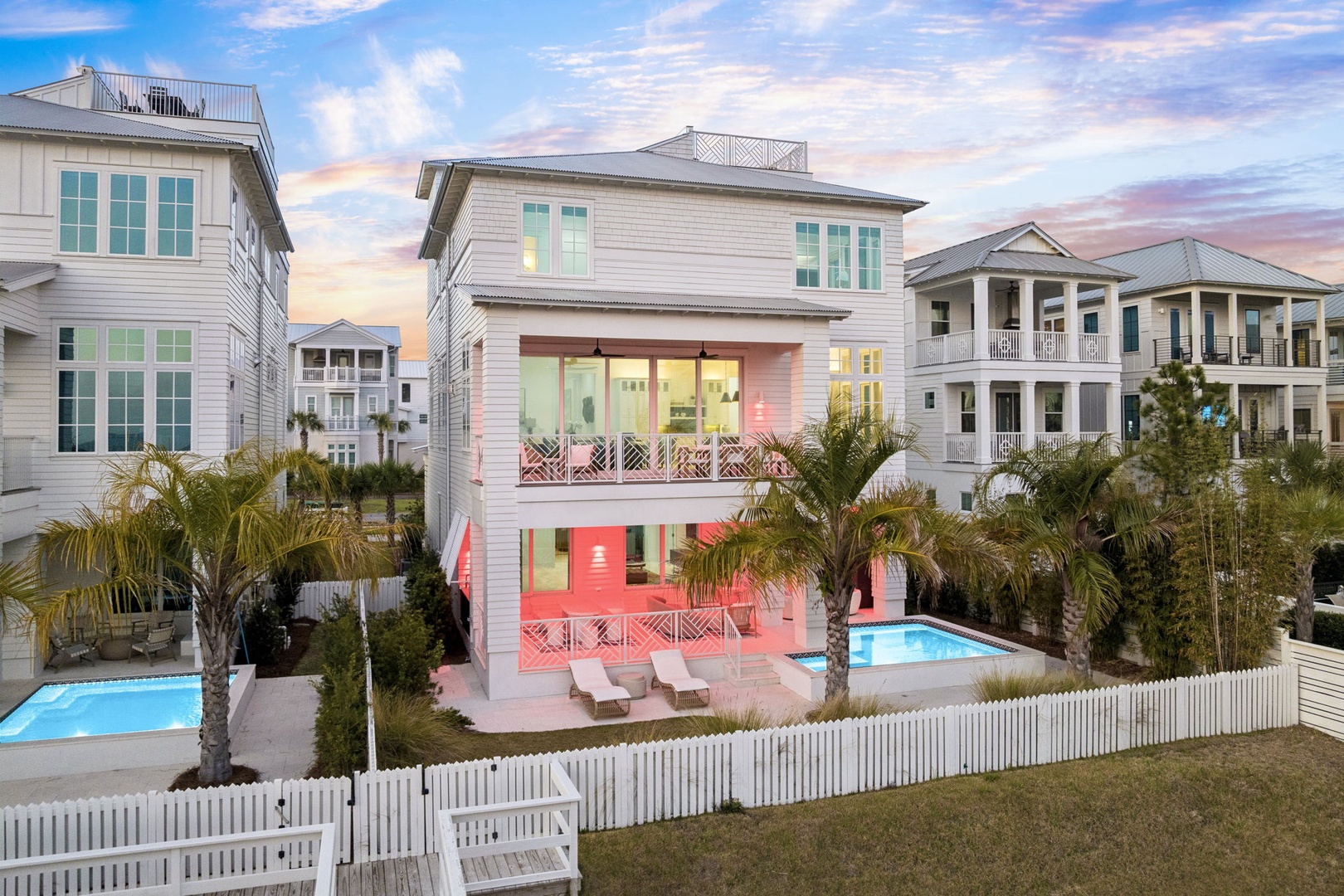 Stunning beachside retreat featuring a private pool surrounded by tropical palms in an upscale coastal neighborhood.