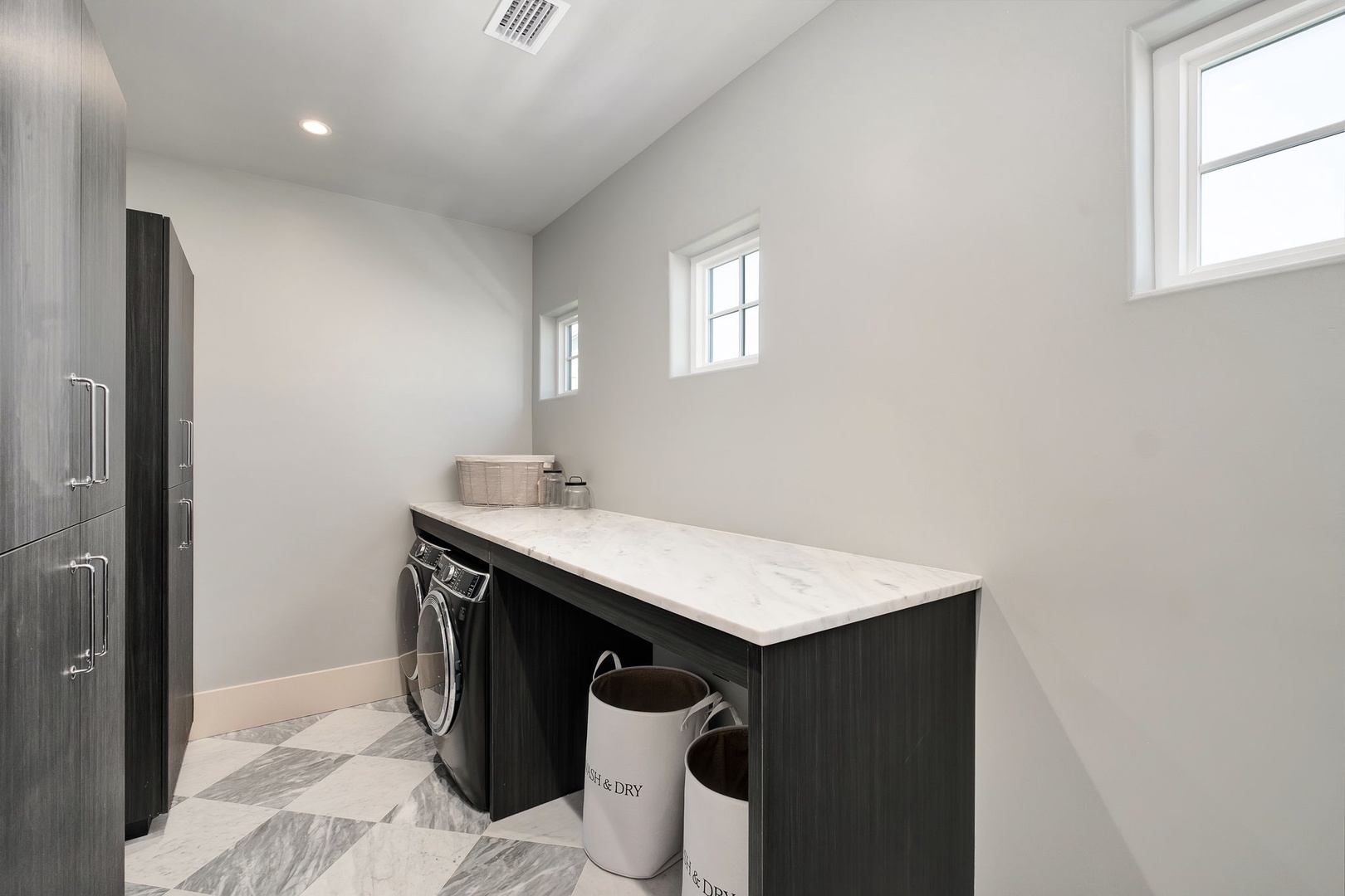 Your dedicated laundry room features modern appliances and marble countertops, making household tasks feel effortless during your stay.