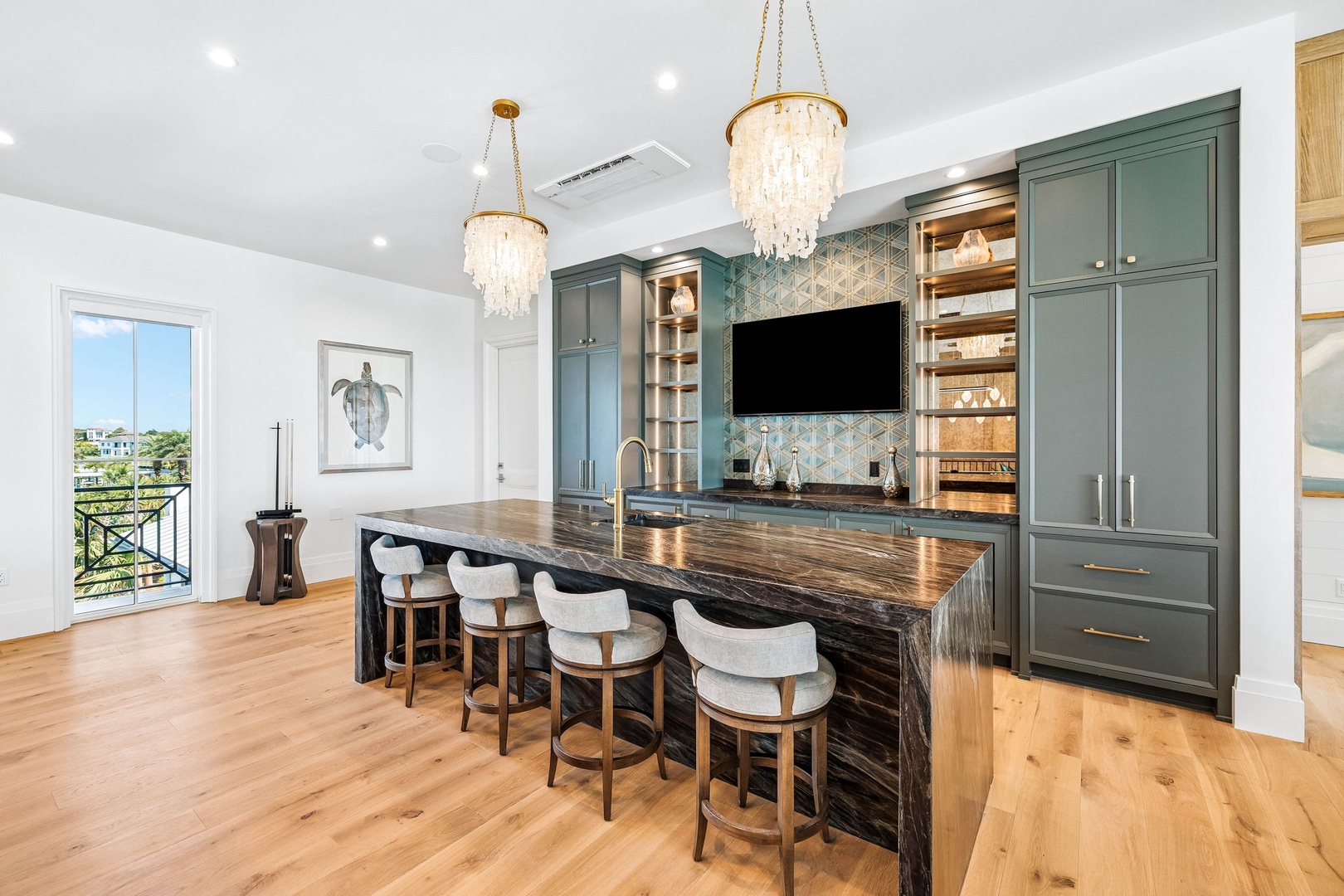 Gather around this stunning kitchen island with seating for six. Elegant chandeliers illuminate the space, while the chef-worthy fixtures and stylish cabinetry create the perfect setting for your vacation meals and memorable conversations.