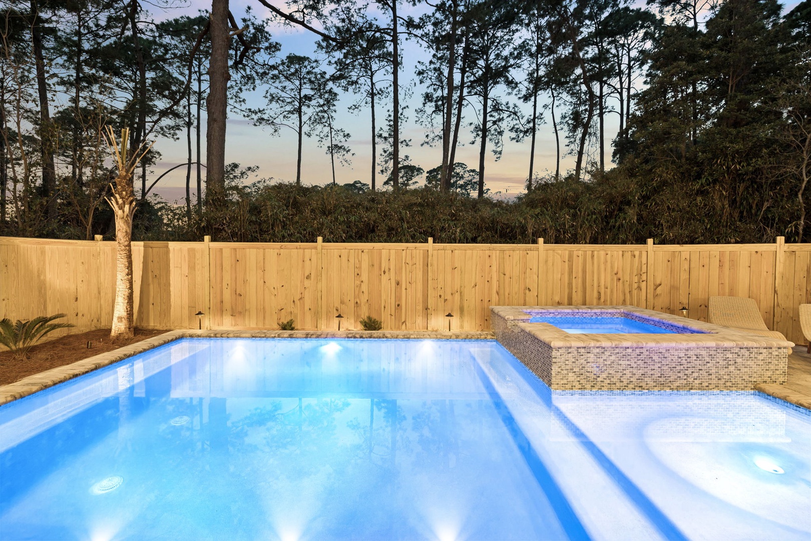Your private oasis awaits with a sparkling pool and bubbling hot tub, perfectly lit for magical evening swims.