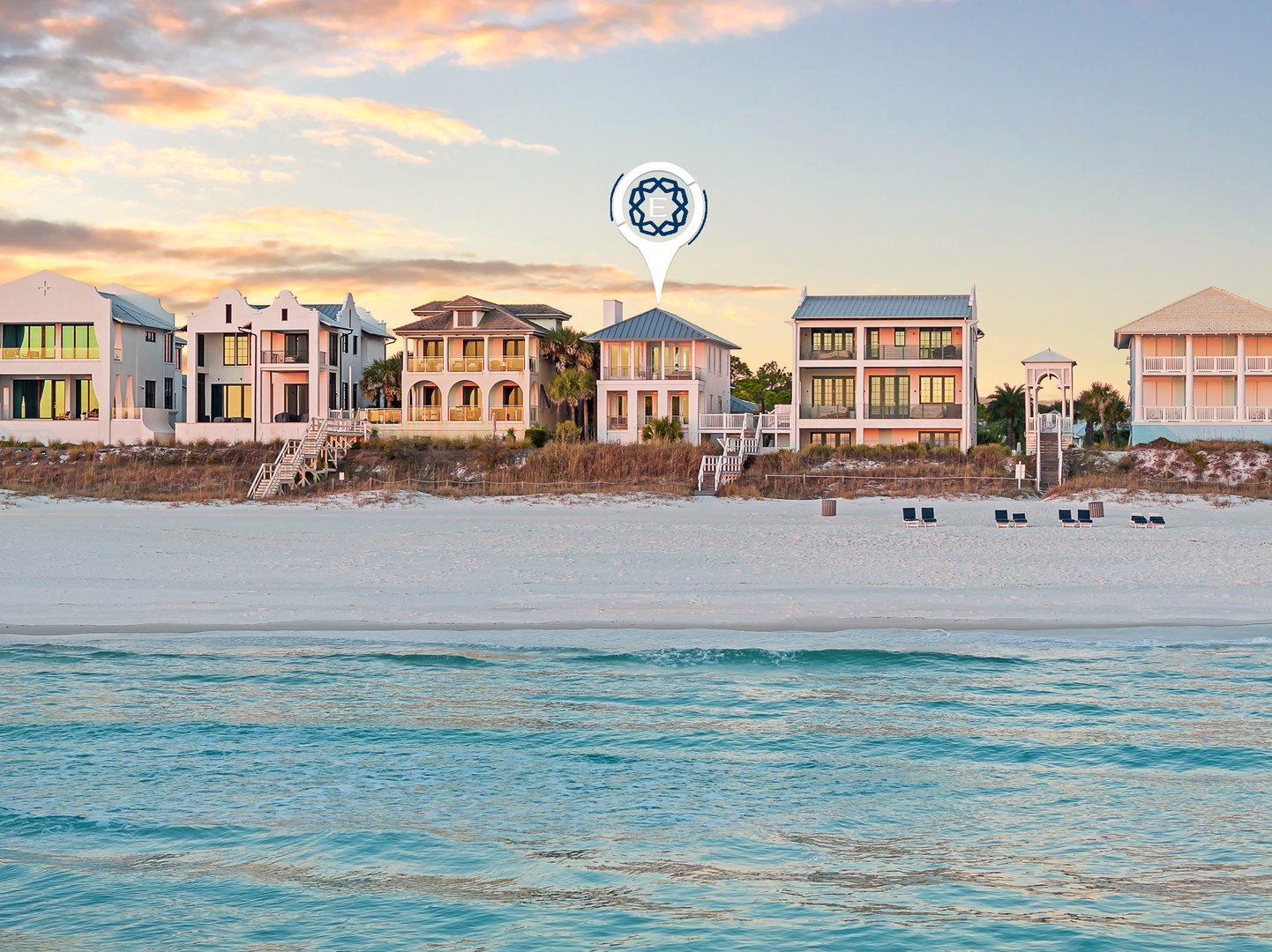 Stunning beachfront vacation rentals line the pristine white sand with crystal-clear turquoise waters just steps away.