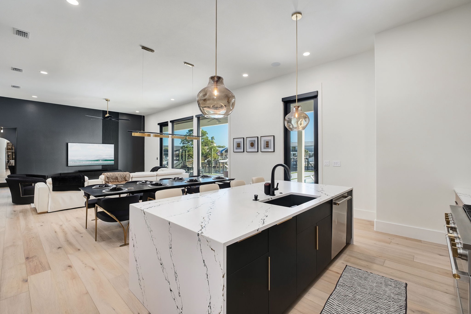 Your modern open-plan space seamlessly blends kitchen and living, featuring sleek marble countertops and stylish pendant lighting for memorable gatherings.
