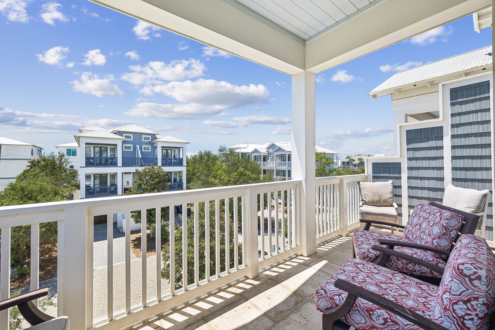 Settle into your covered balcony and soak up the coastal neighborhood views. Comfy seating invites morning coffee or evening relaxation under open skies.