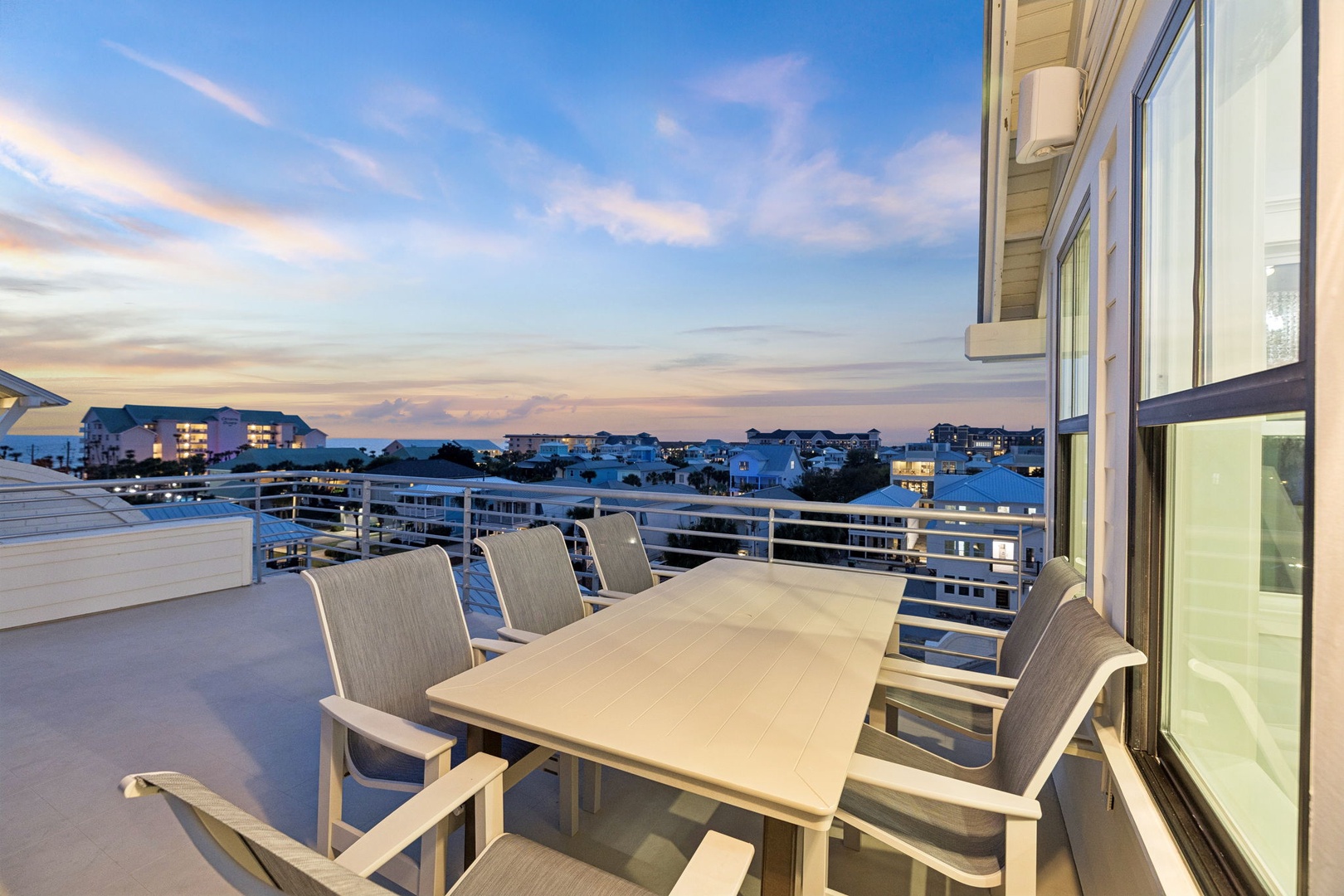 Step onto your private rooftop terrace and dine al fresco as twilight paints the sky in soft pastels above the neighborhood.