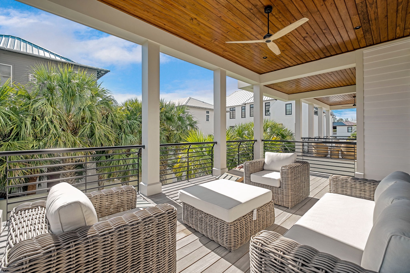 Unwind in your private covered terrace with plush wicker seating, where warm wood ceilings and tropical breezes create your perfect outdoor retreat.