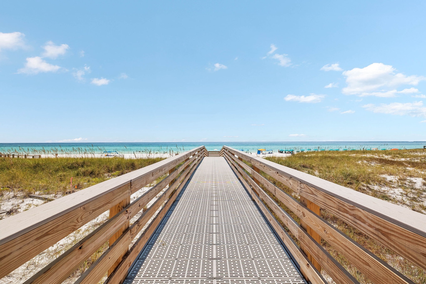 A boardwalk pathway leads you directly to the soft white sands and inviting turquoise waters of your private beach access.