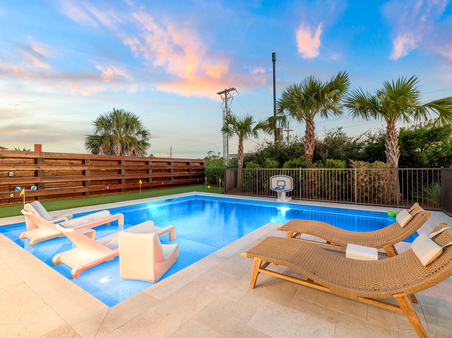 Your private pool paradise awaits under painted skies—lounge on comfortable sunbeds, cool off in crystal-blue water, and enjoy tropical palm breezes as the day melts into evening.