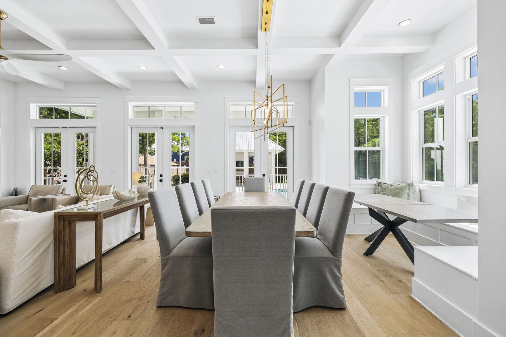 Step into your bright, airy dining and living space with soaring coffered ceilings, elegant modern finishes, and natural light streaming through French doors—perfect for gathering with loved ones or savoring morning coffee.
