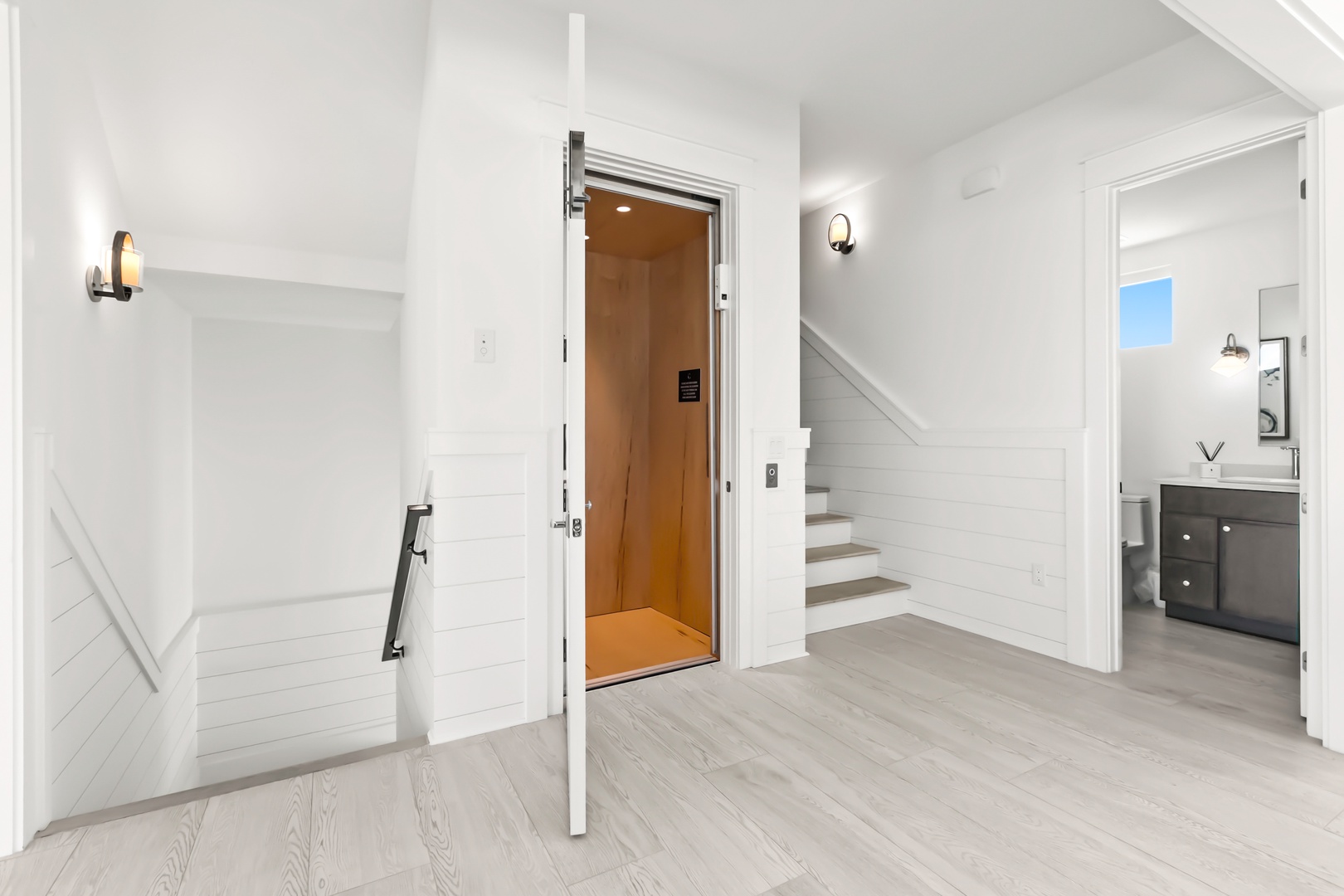 A bright, airy interior hallway with elegant shiplap detailing and modern finishes connects your bedroom levels seamlessly, with an elevator ensuring effortless access throughout your stay.