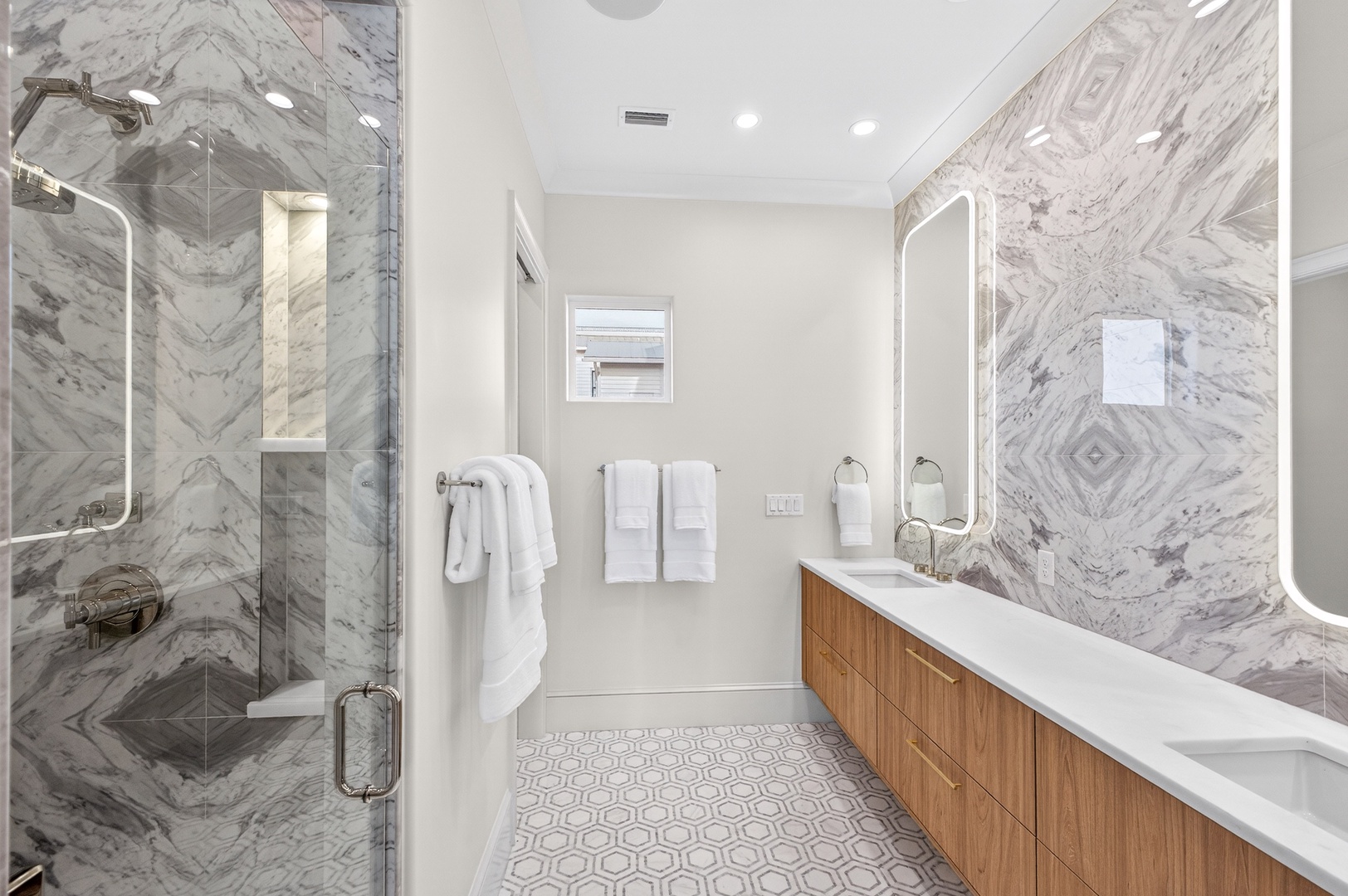 Step into your luxurious marble bathroom retreat, where crisp white linens await your arrival after a refreshing shower.