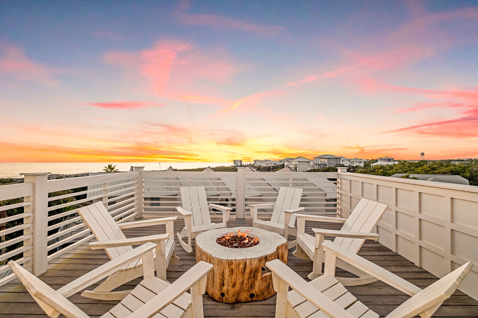 Stunning rooftop deck with breathtaking sunset views creates perfect evening gathering spot for memorable moments.