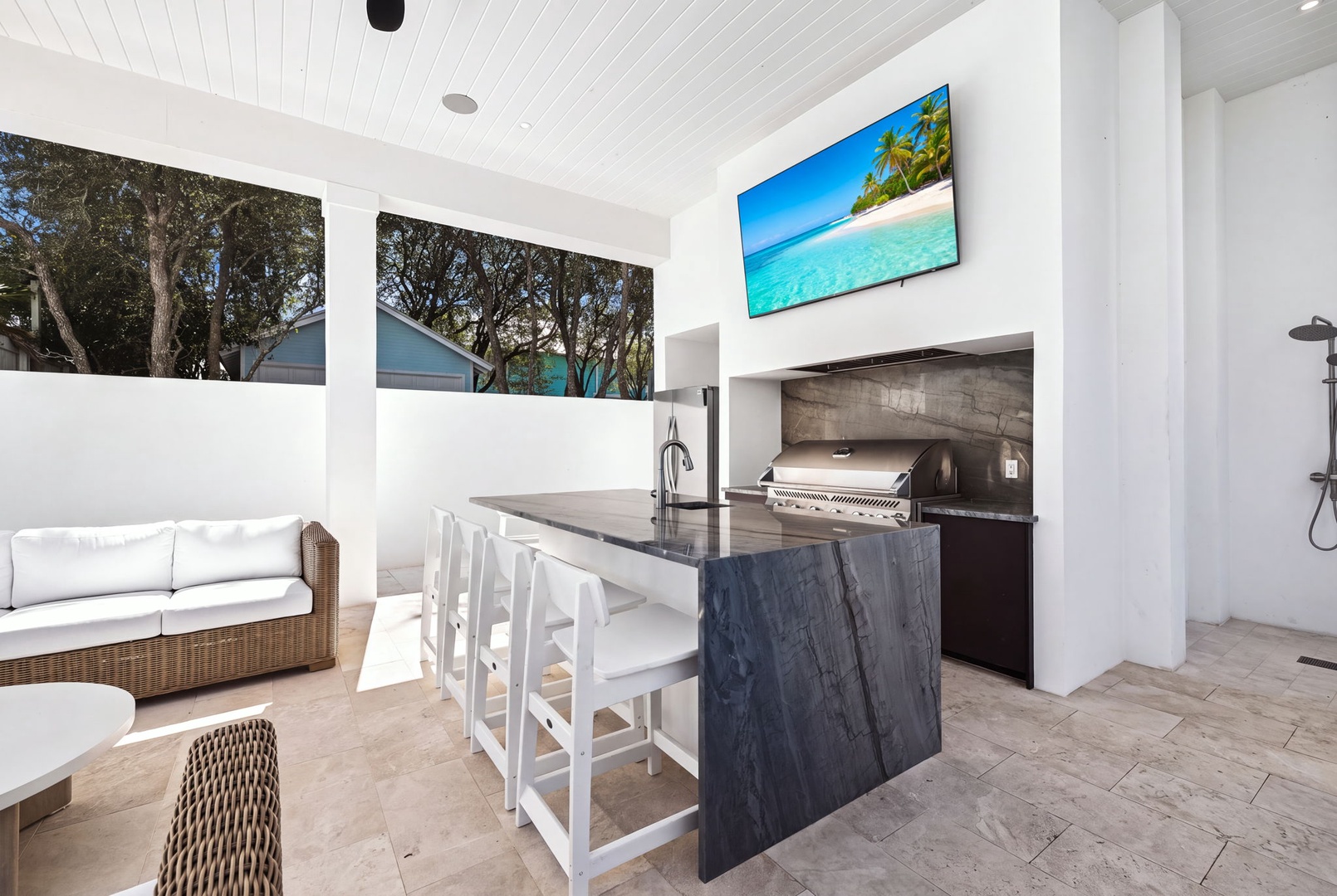 Your private outdoor kitchen and lounge await—complete with a sleek grill, marble bar seating, and poolside comfort. Perfect for savoring meals under open skies.