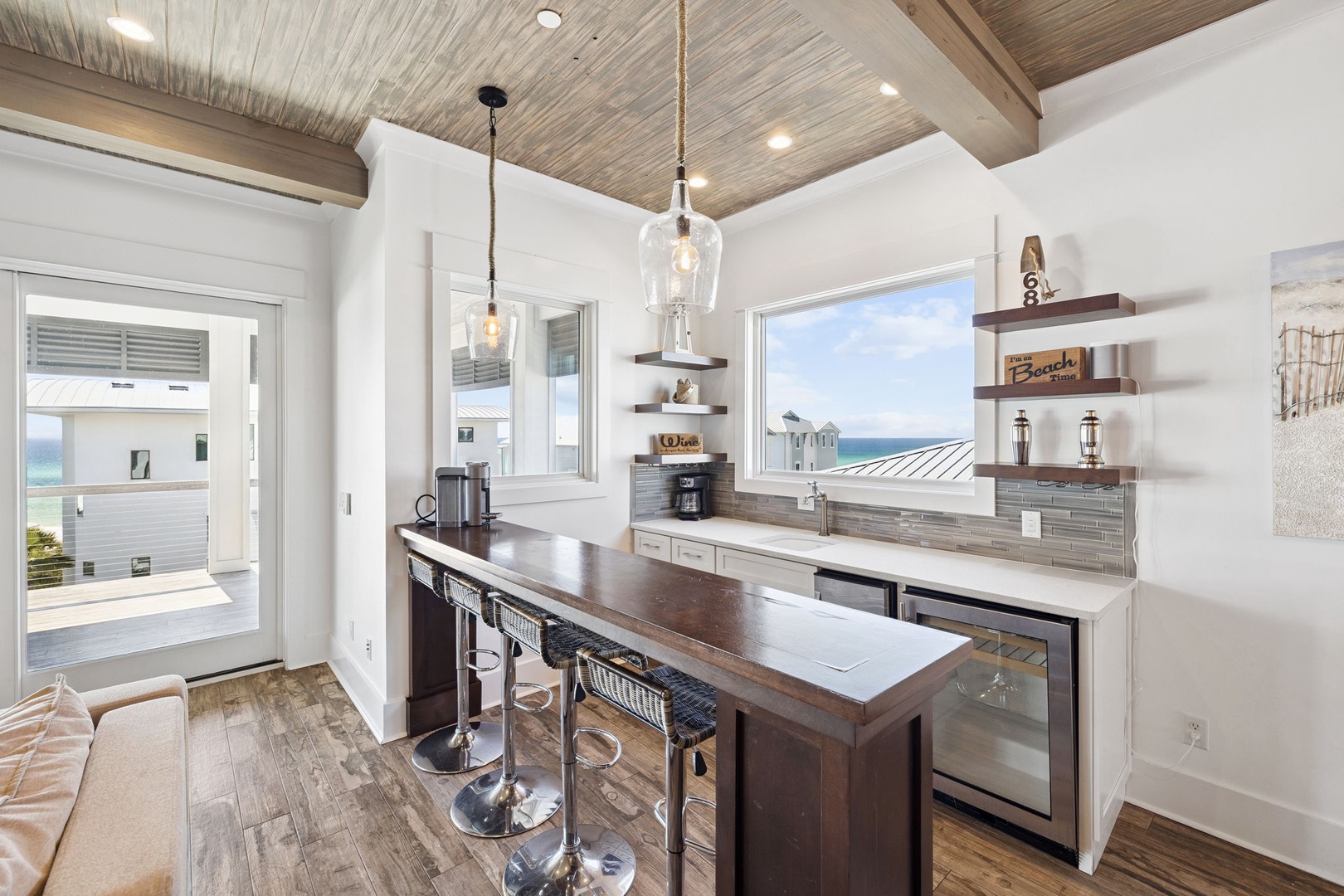 Your coastal kitchen features stunning sea views, modern appliances, and a breakfast bar perfect for morning coffee while watching the waves.