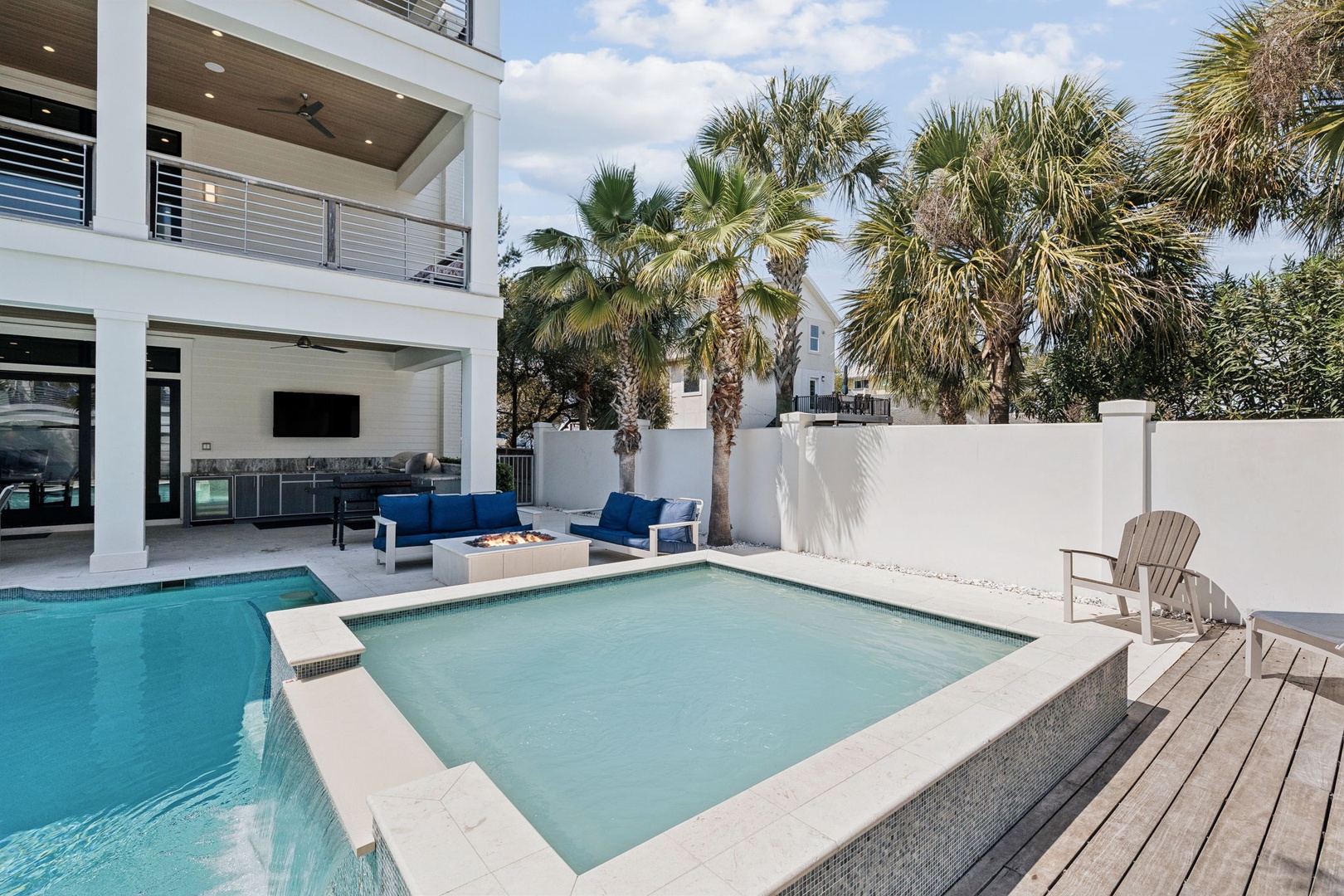 Relax in your private paradise with sparkling pool, hot tub, and tropical palms creating the perfect outdoor retreat.