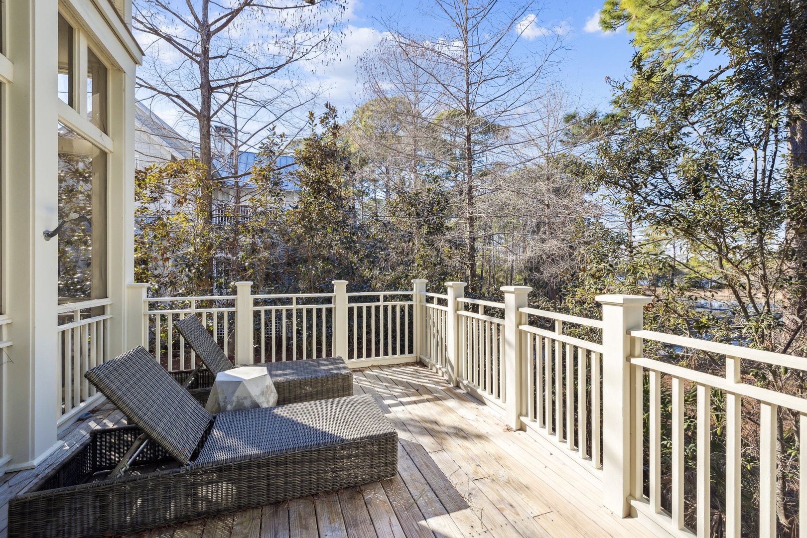 Unwind on your private deck with comfortable loungers surrounded by peaceful treetops and natural light streaming through the canopy.