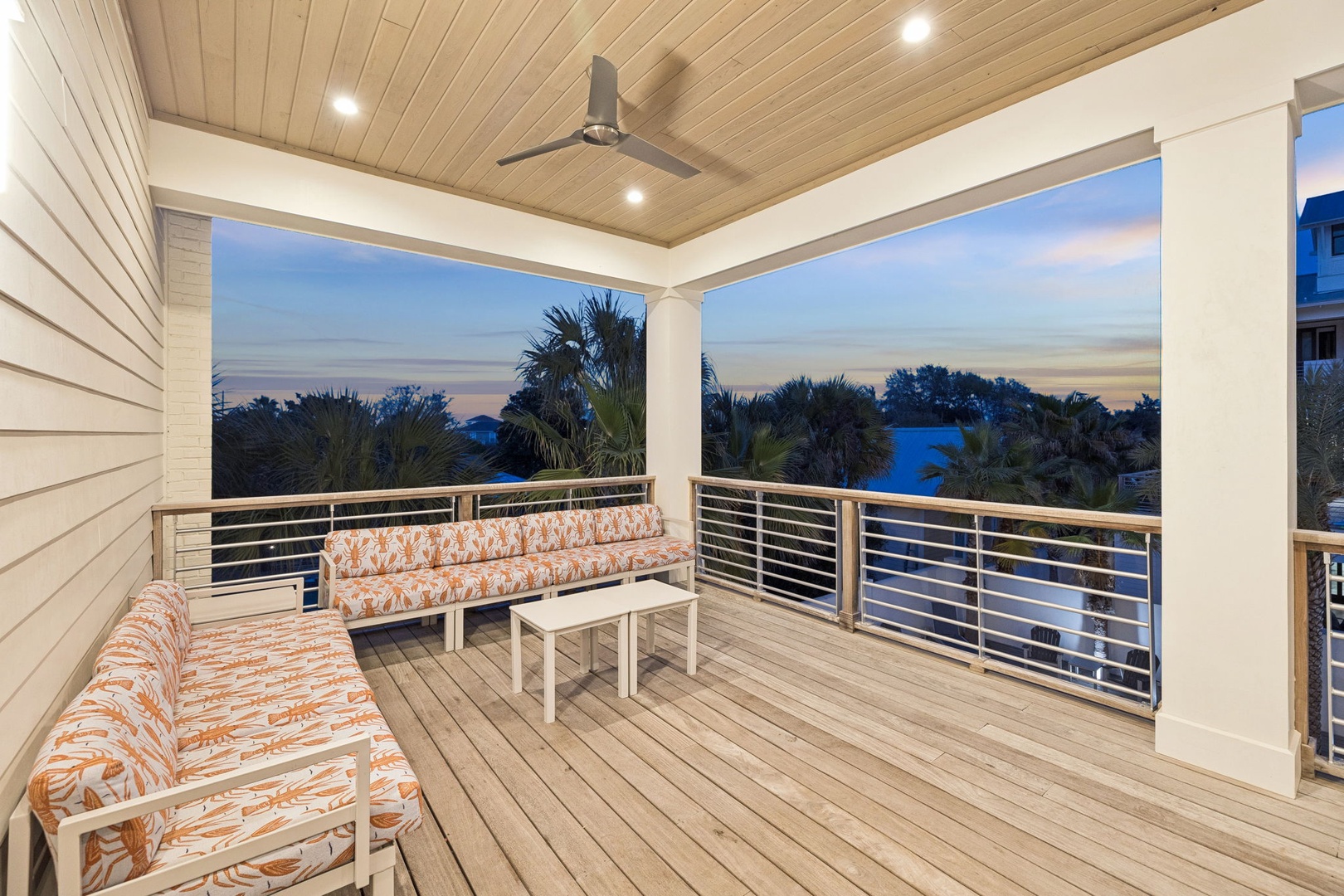 Unwind on your private covered deck with tropical palm views and gentle ceiling fan breezes.