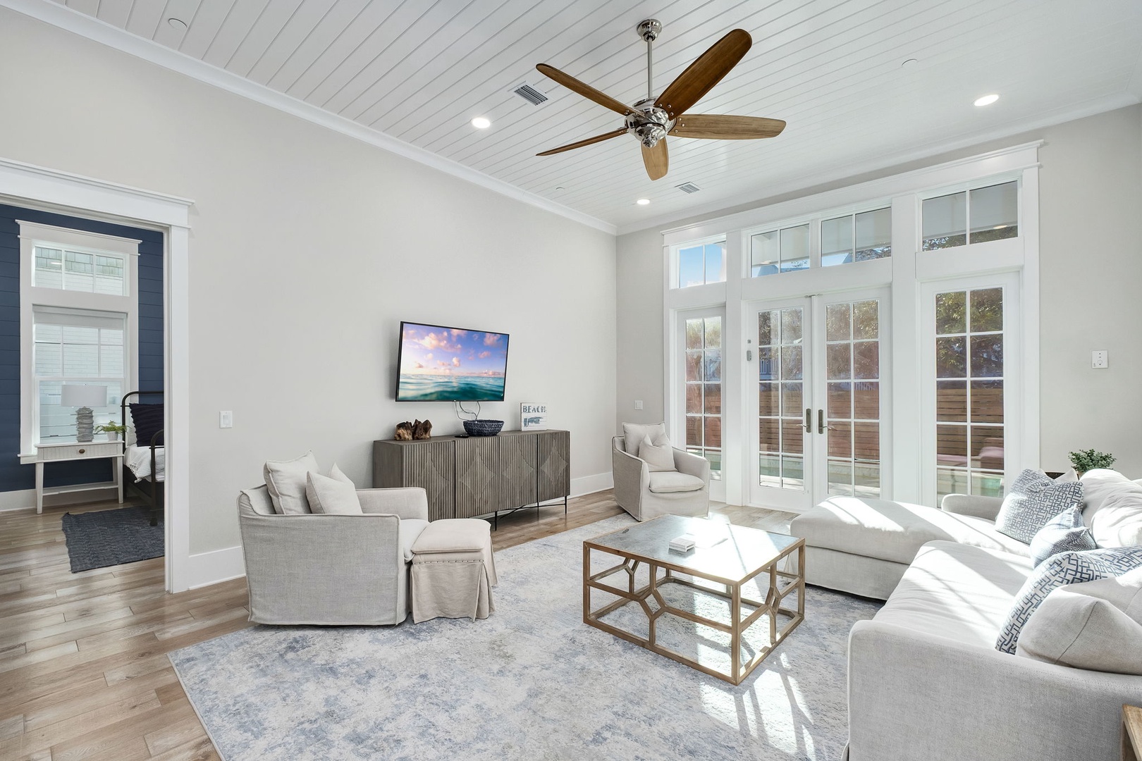 Settle into your bright living space with plush seating, warm wood floors, and French doors opening to your private outdoor area.