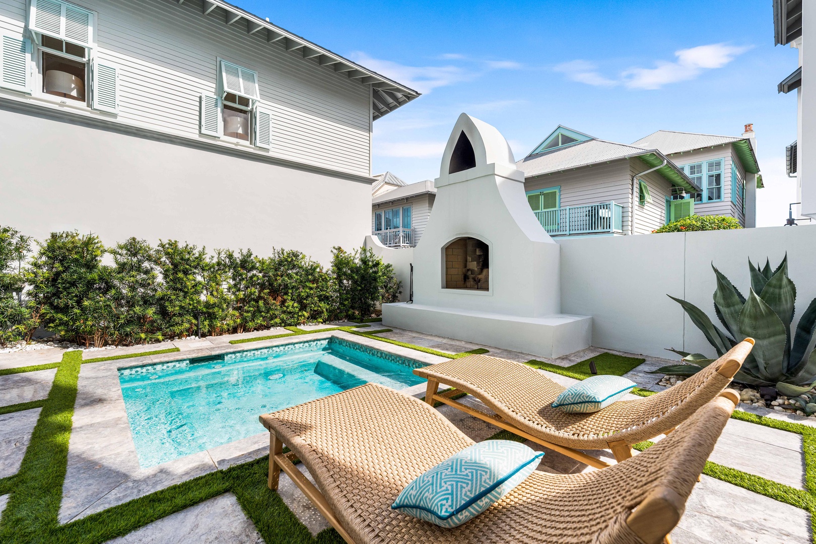 Dive into your private oasis with a sparkling pool, sun loungers, and tropical landscaping in this secluded courtyard retreat.