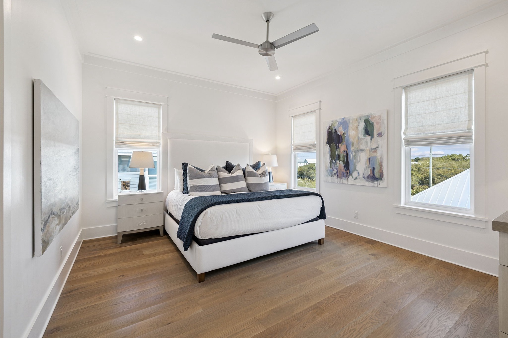 Drift off in this serene bedroom where soft artwork and natural light create your peaceful retreat.