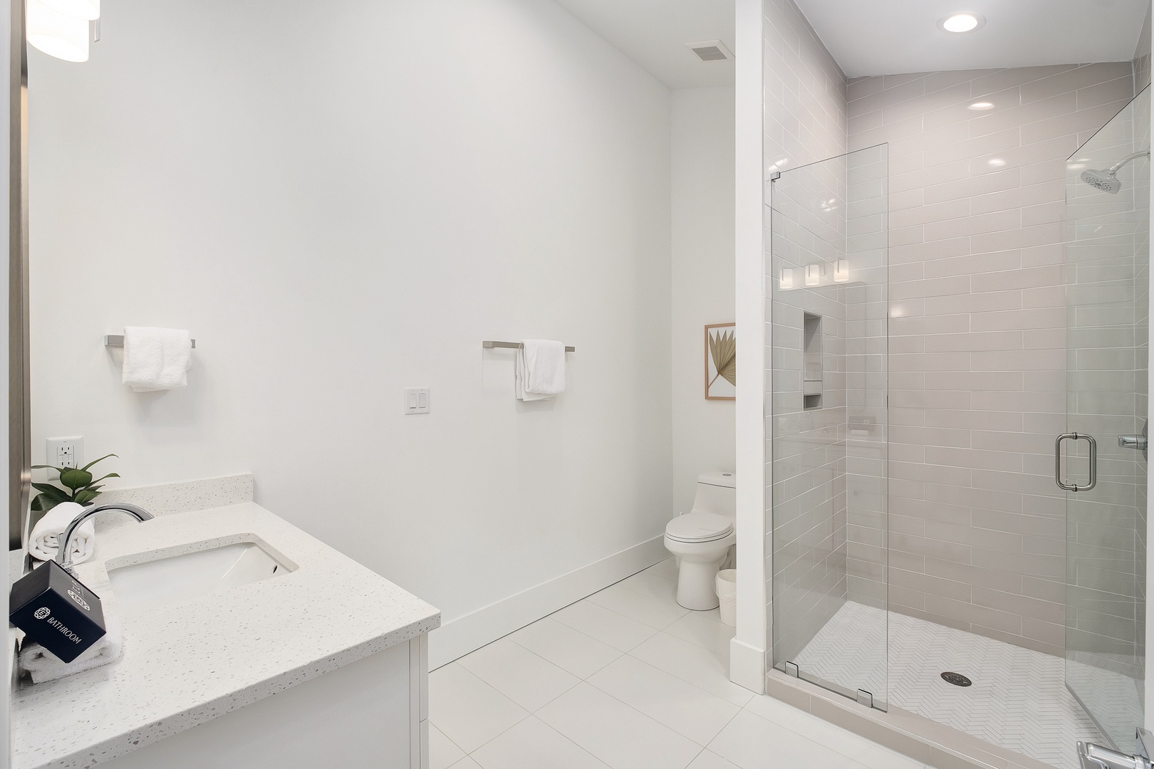 Your pristine bathroom features a luxurious soaking tub and spacious glass shower, creating a spa-like retreat for ultimate relaxation.