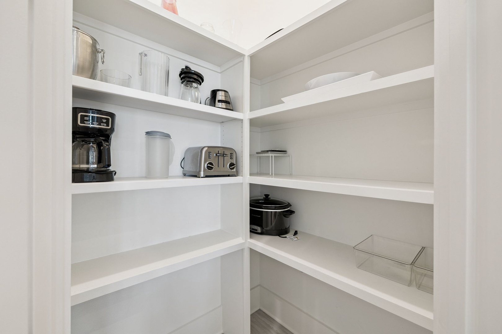 Your well-organized pantry keeps everything within reach—coffee maker, toaster, and ample storage space for all your culinary needs.