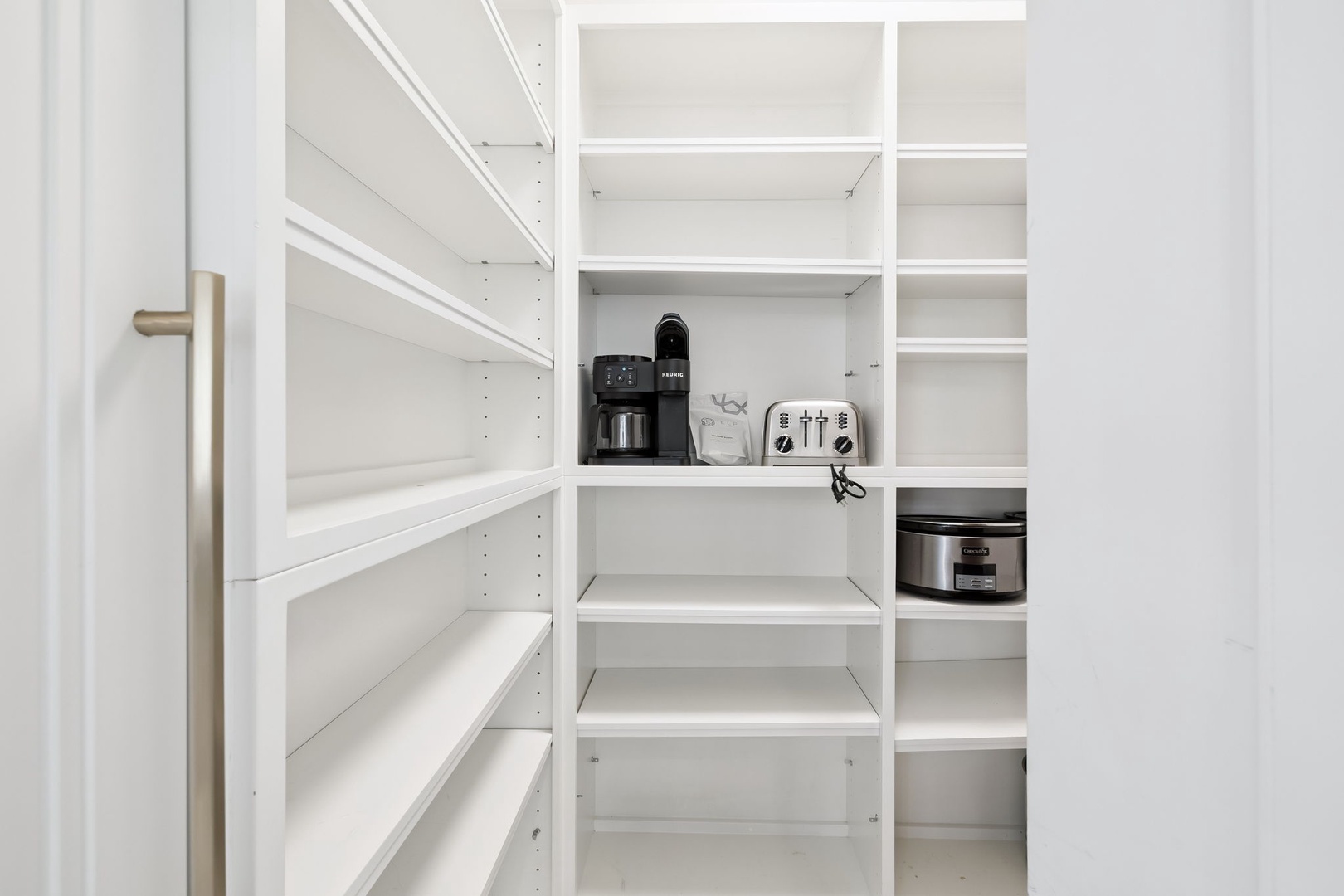 Your well-organized pantry keeps everything within reach—coffee maker, toaster, and plenty of storage for all your vacation essentials.