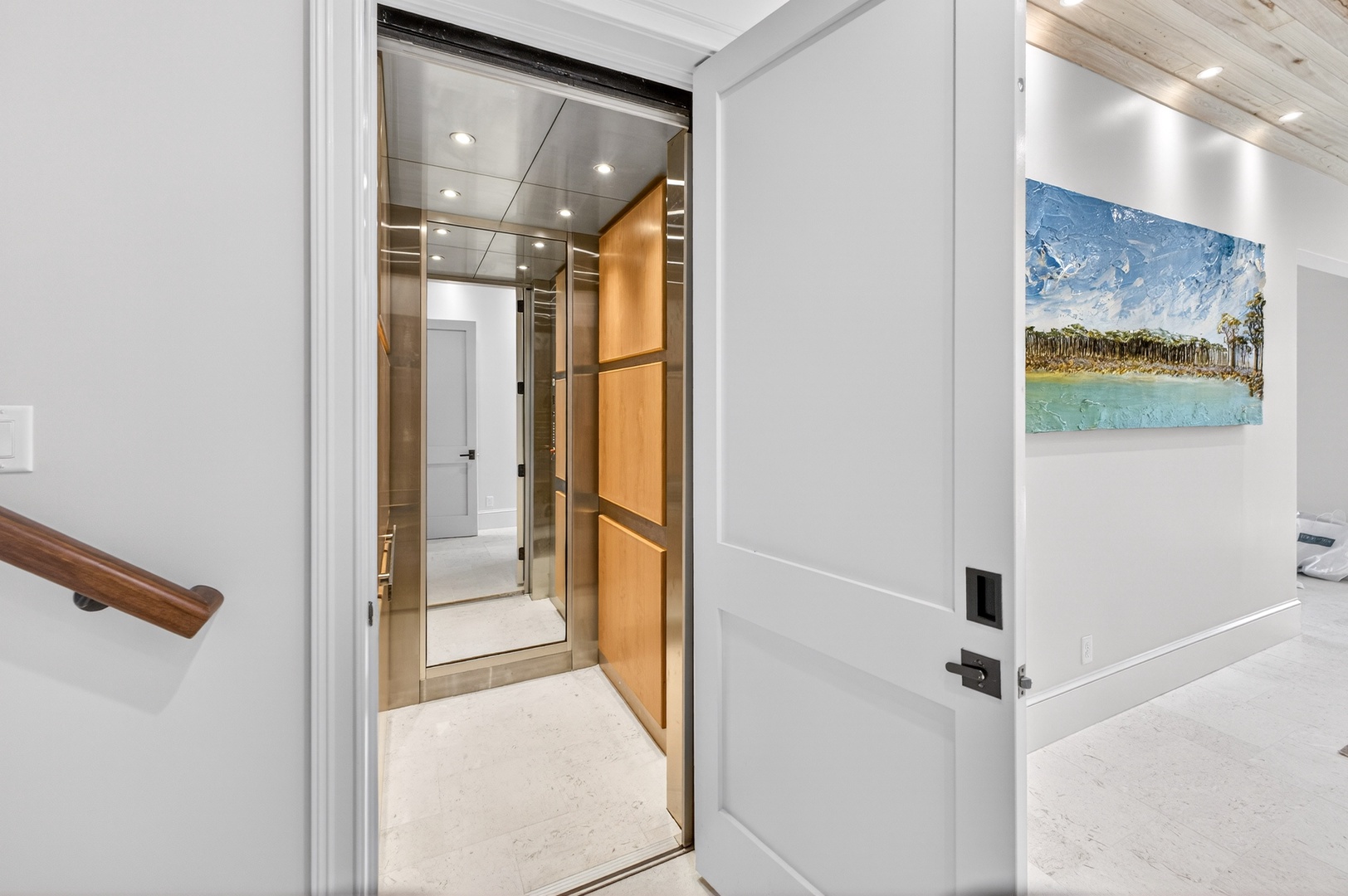 Step into your private elevator with warm wood accents and modern lighting, offering seamless access throughout your multi-level retreat.
