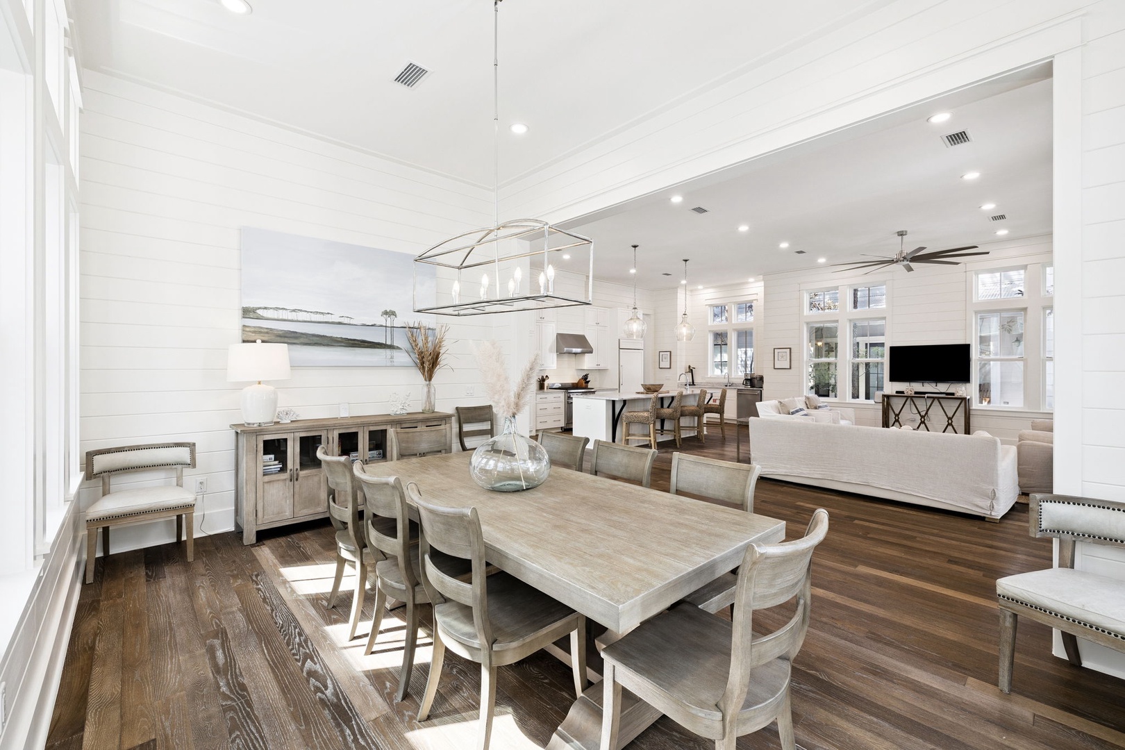 Gather around your spacious dining table while natural light streams through tall windows, creating the perfect setting for memorable meals together.