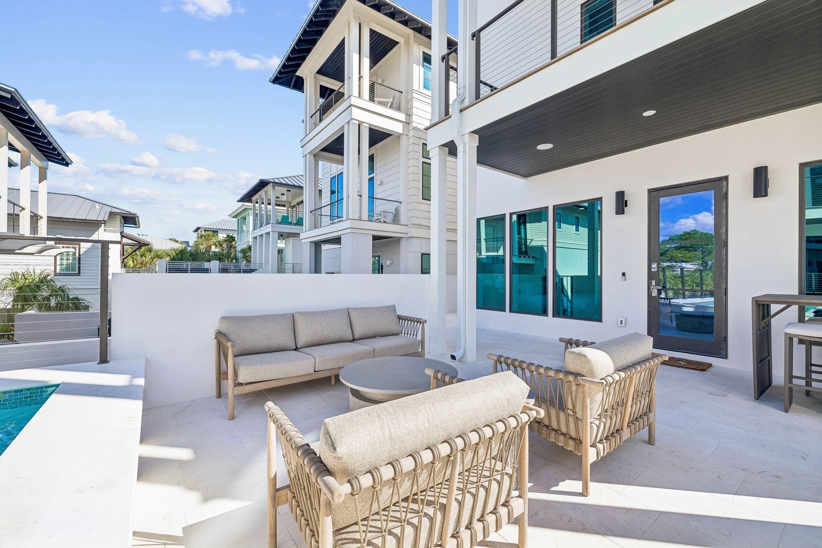 Unwind in your private outdoor lounge with plush seating, perfect for morning coffee or sunset cocktails by the pool.