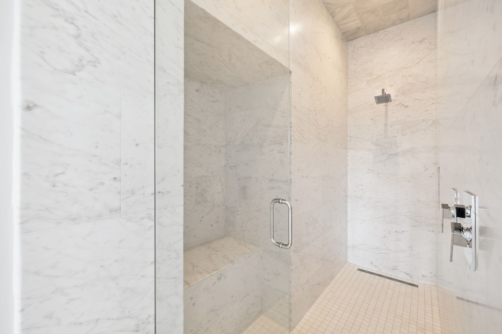 Step into your spa-like marble shower with rainfall head and sleek glass enclosure - your private sanctuary awaits.