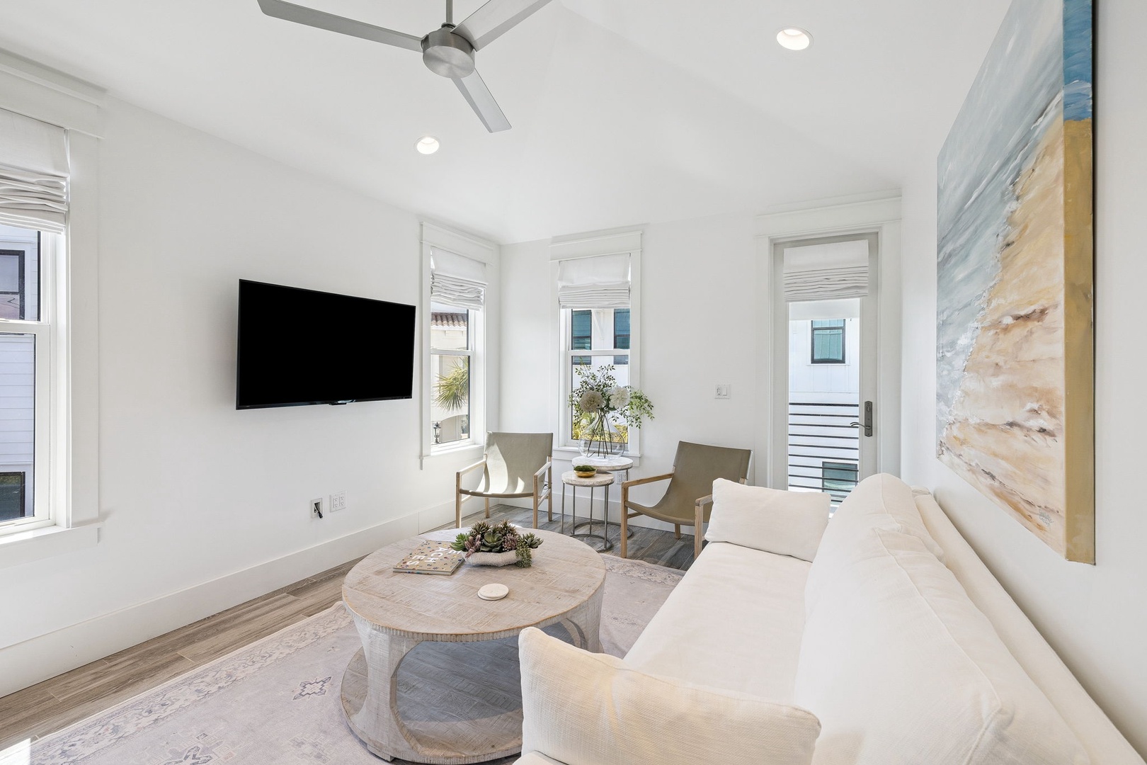 Sink into plush seating while ocean breezes flow through your bright, airy living room with modern coastal touches.