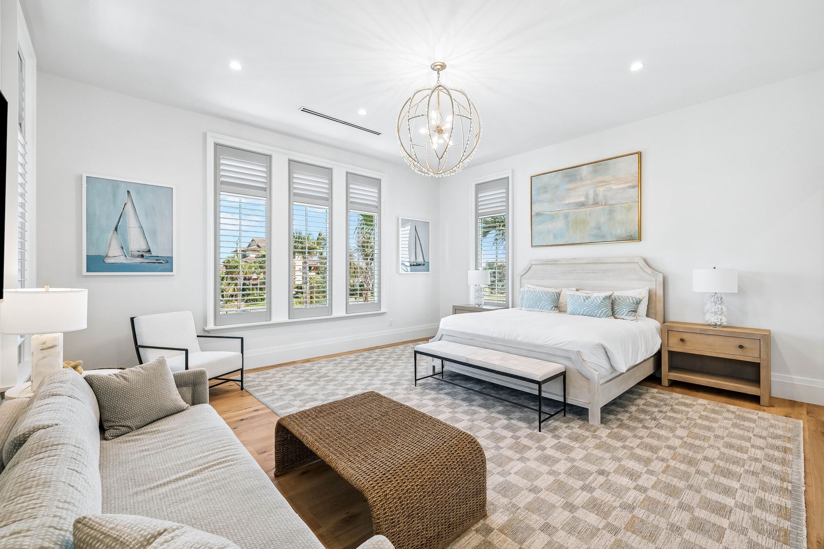 Light-filled bedroom with coastal elegance, king bed, plantation shutters, and ocean views. Soft linens and thoughtful touches create a peaceful sanctuary.