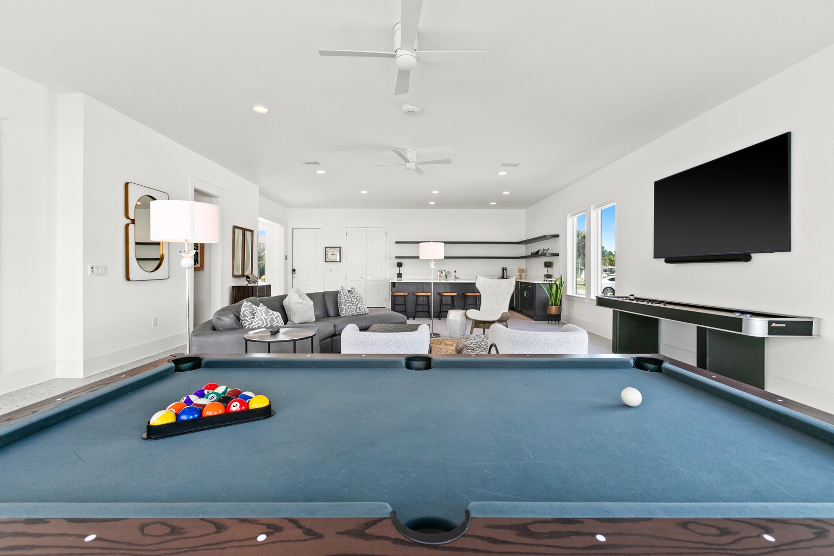 Challenge friends to billiards in your spacious game area featuring a full-size pool table, comfortable lounge seating, and a modern entertainment system for laid-back evenings indoors.