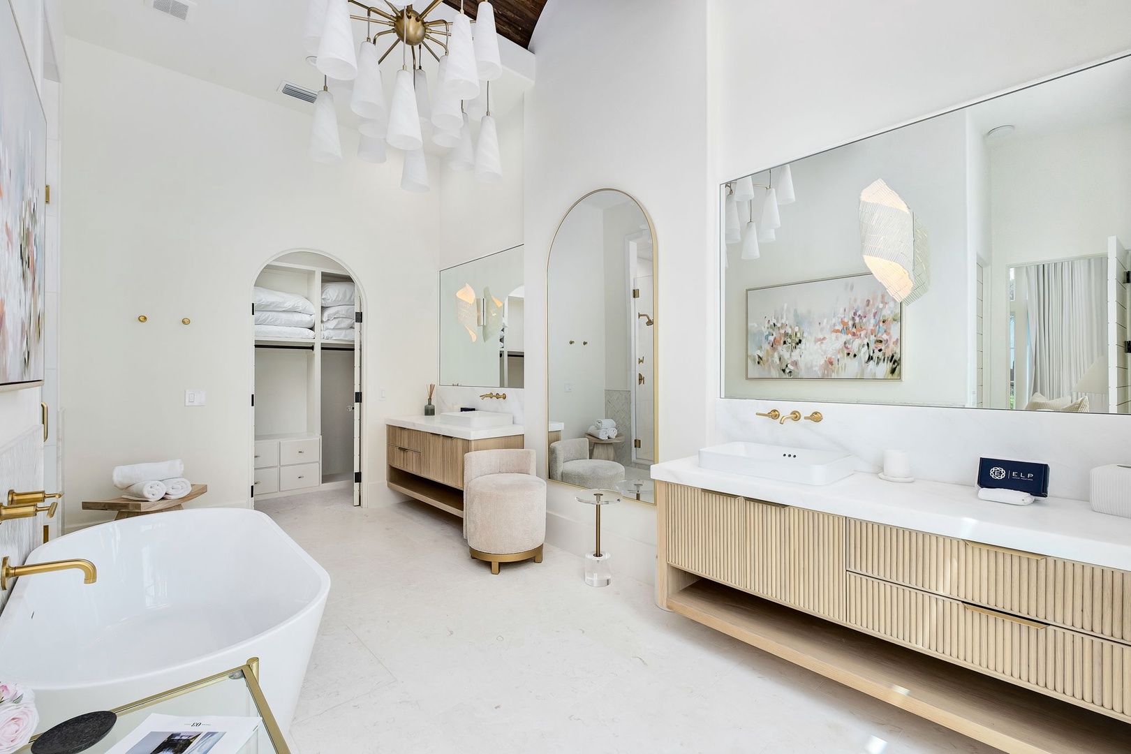 Sink into pure luxury in this spa-like ensuite, where soaring ceilings, a stunning chandelier, and a freestanding tub set the scene for your ultimate relaxation.