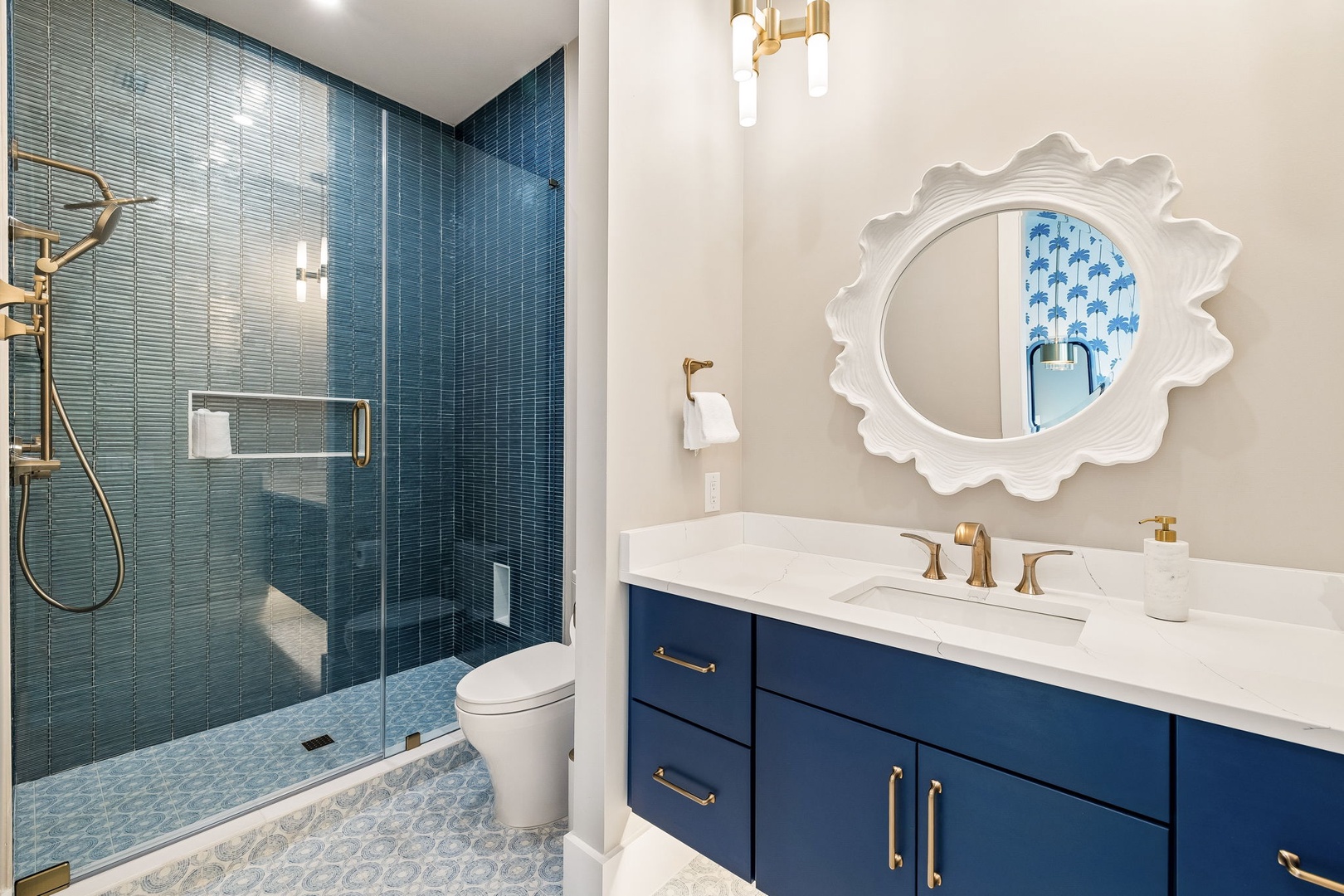Step into your private spa with stunning blue tile, a walk-in shower, and elegant finishes that make every morning feel luxurious.