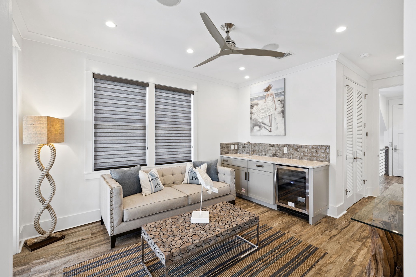 Relax in your stylish living space with modern coastal vibes, complete with wet bar and contemporary furnishings for entertaining.