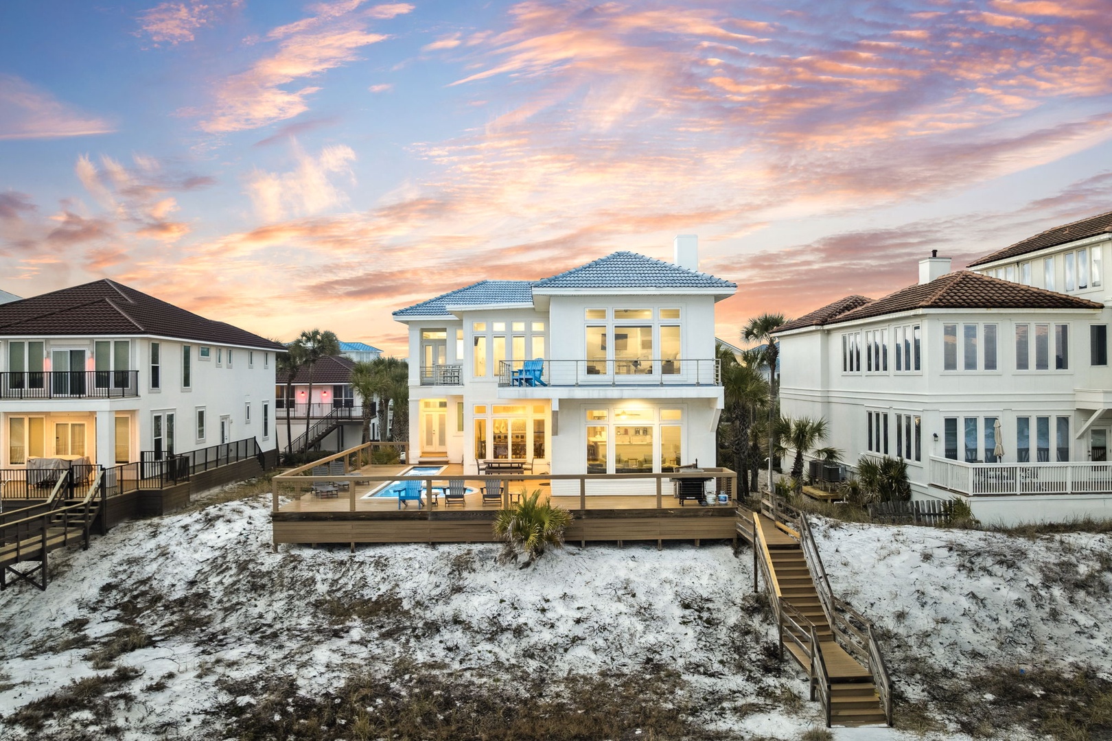 Stunning beachfront property with private pool deck at sunset, featuring modern architecture and coastal luxury in this exclusive neighborhood.
