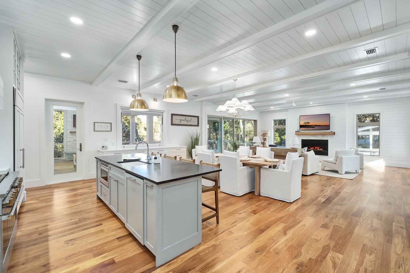 Step into this stunning open-concept space where gleaming hardwood floors flow seamlessly from your gourmet kitchen to cozy living area with fireplace.