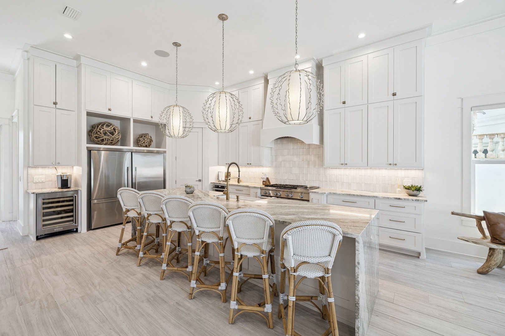 Your dream kitchen awaits with gleaming white cabinetry, stunning pendant lights, and a marble island perfect for morning coffee or evening gatherings.