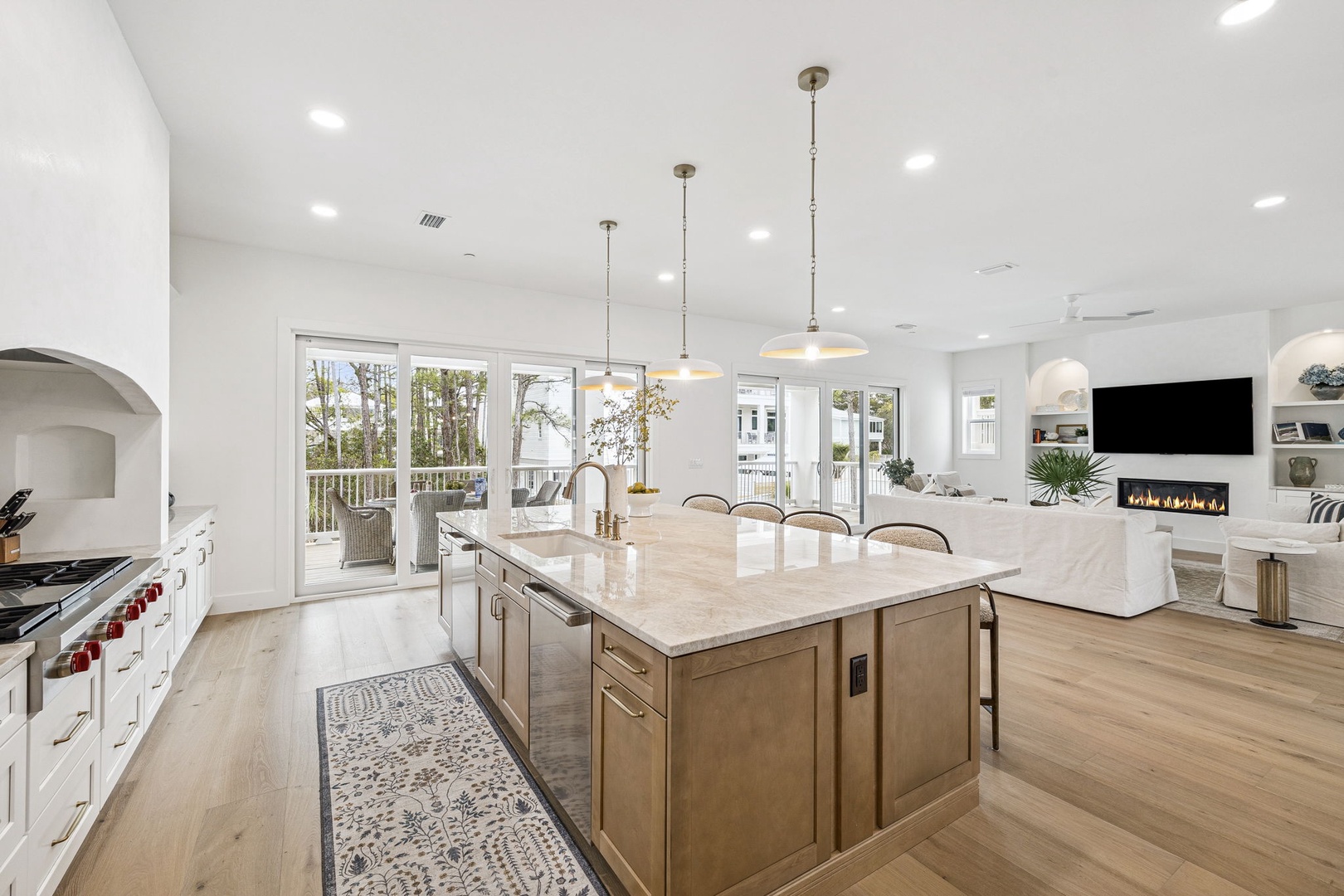 Gather around your spacious kitchen island where marble counters meet warm wood tones, while natural light floods this open sanctuary.